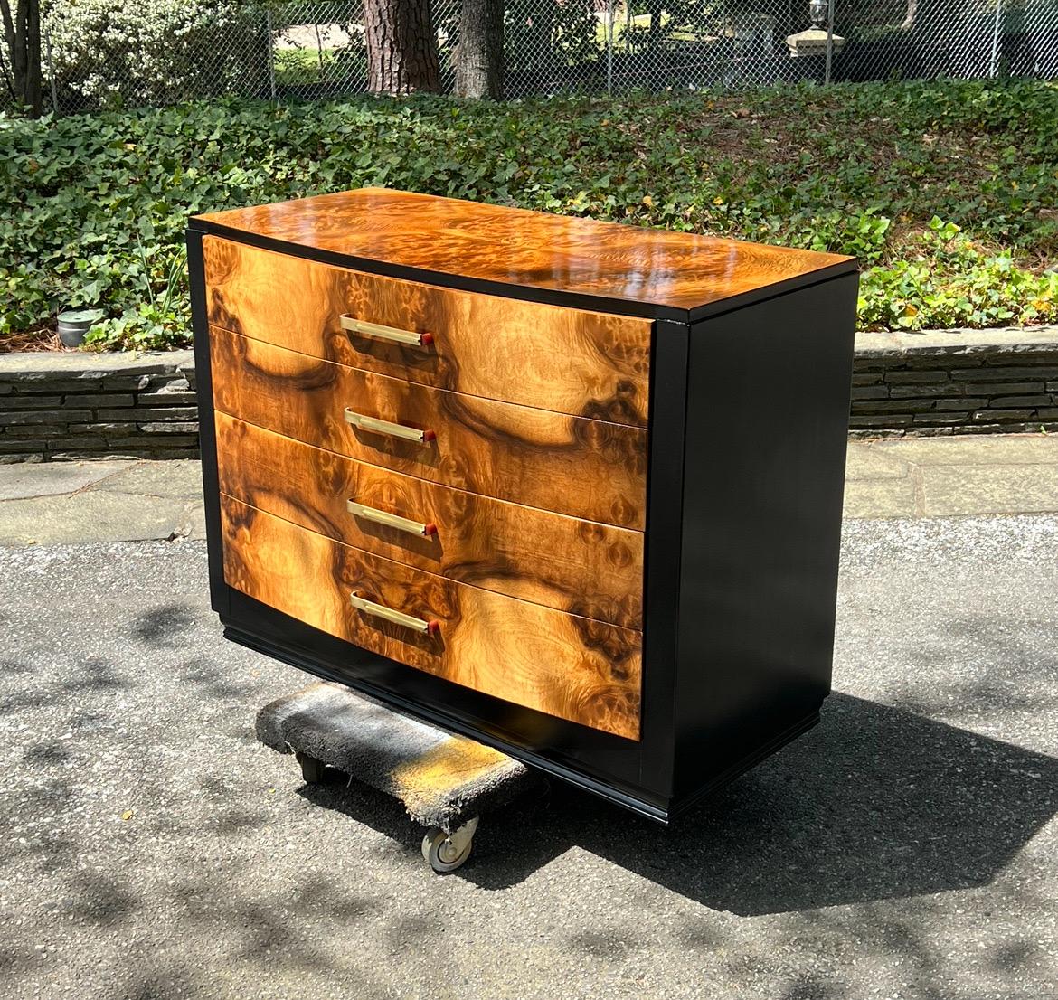 A magnificent Art Deco commode from a rare series designed by the esteemed Donald Deskey for Widdicomb, circa 1935. Elegant mahogany case construction expertly finished in black lacquer. Drawer fronts and top executed in incredible bookmatched black
