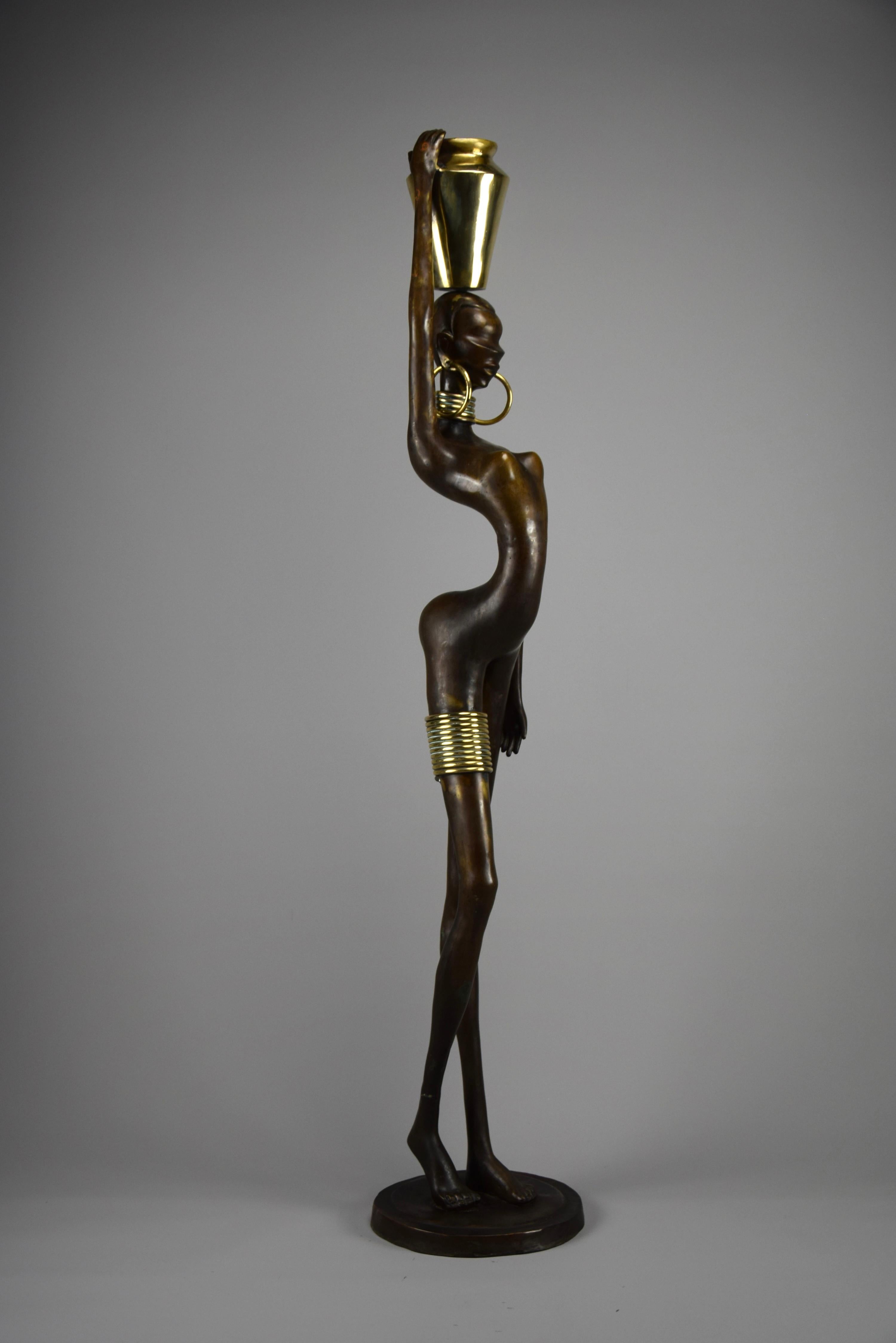 Elevate your living space with this exquisite mid-century modern sculpture, standing at an impressive 118 cm in the style of Karl Hagenauer. Crafted from a harmonious blend of brass and copper, this piece encapsulates the timeless elegance and