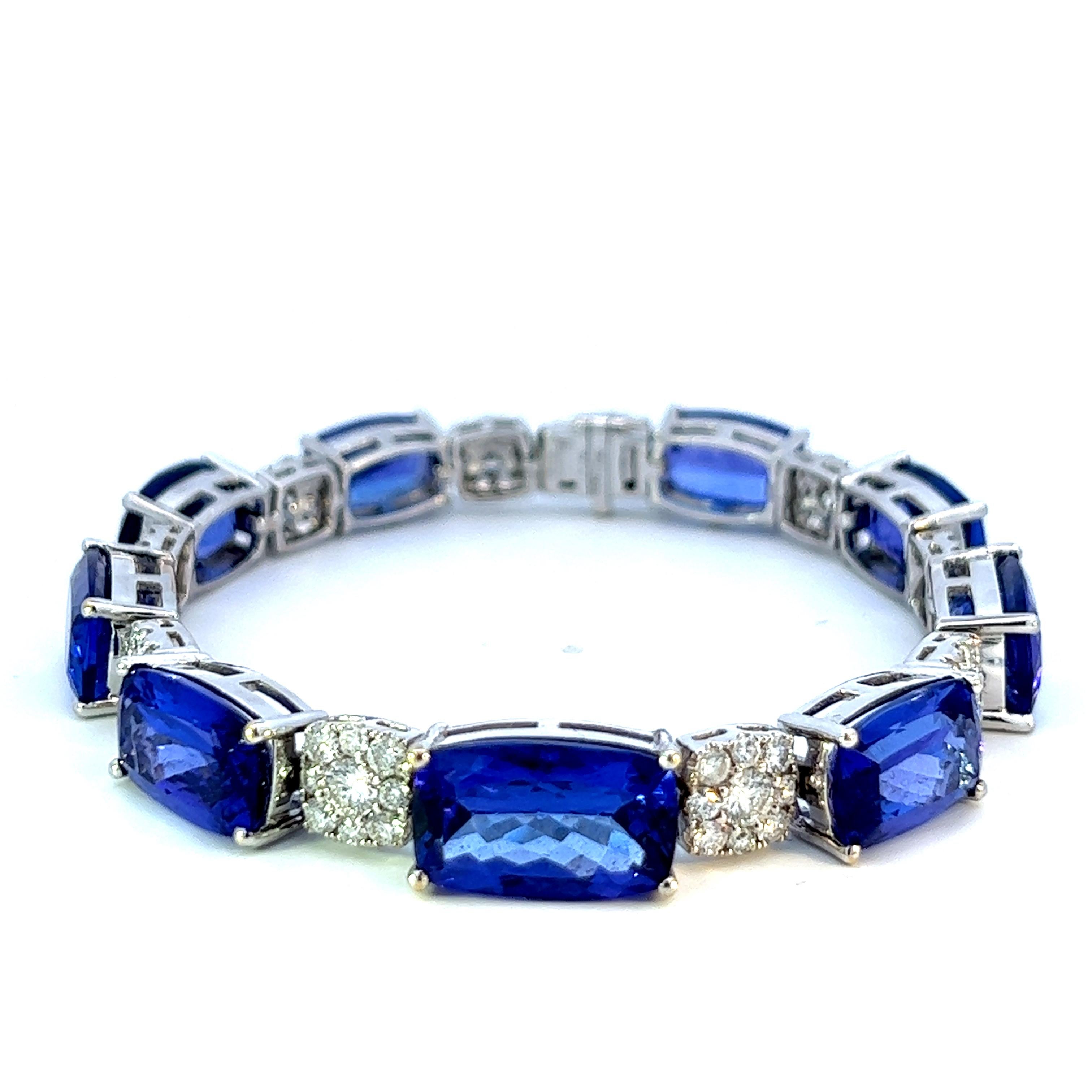 Introducing the  18KW Tanzanite Cushion Bracelet, a brand new masterpiece exuding elegance and luxury. With 45.39 carats of vivid tanzanite and 3.96 carats of sparkling diamonds, this bracelet is a captivating statement piece. Crafted with precision