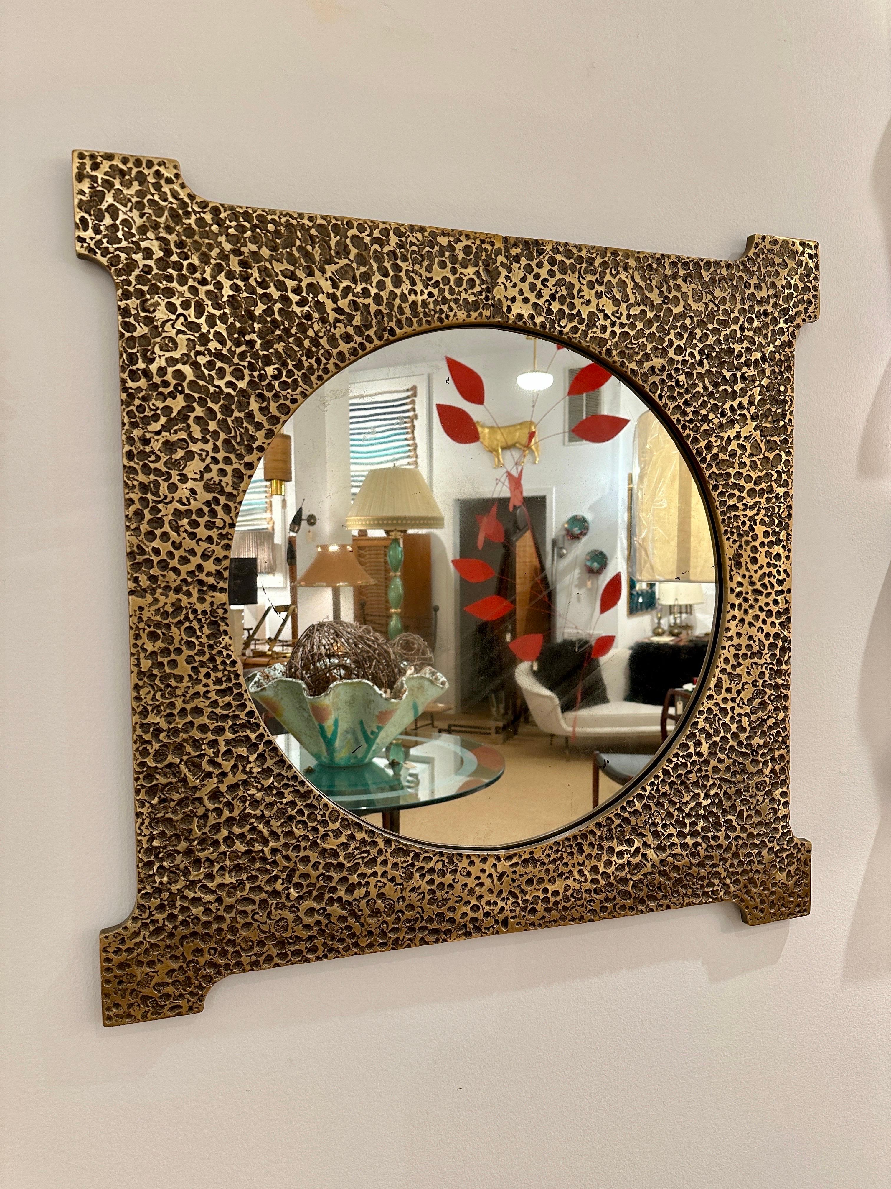 This brutal heavy bronze frame from France shows a wonderful patina, as well as an aged mirror.  THIS ITEM IS LOCATED AND WILL SHIP FROM OUR EAST HAMPTON, NY SHOWROOM.