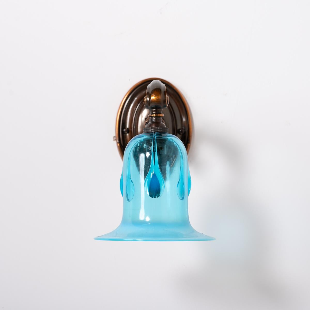 Quality Cast Copper Wall Scones with Blue Glass Drop Shades
SOLD AS A PAIR

Beautiful quality cast copper wall sconces with decorative detailing and flowing design typical of the Art Nouveau style.

English made circa 1920

Hand crafted vivid blue