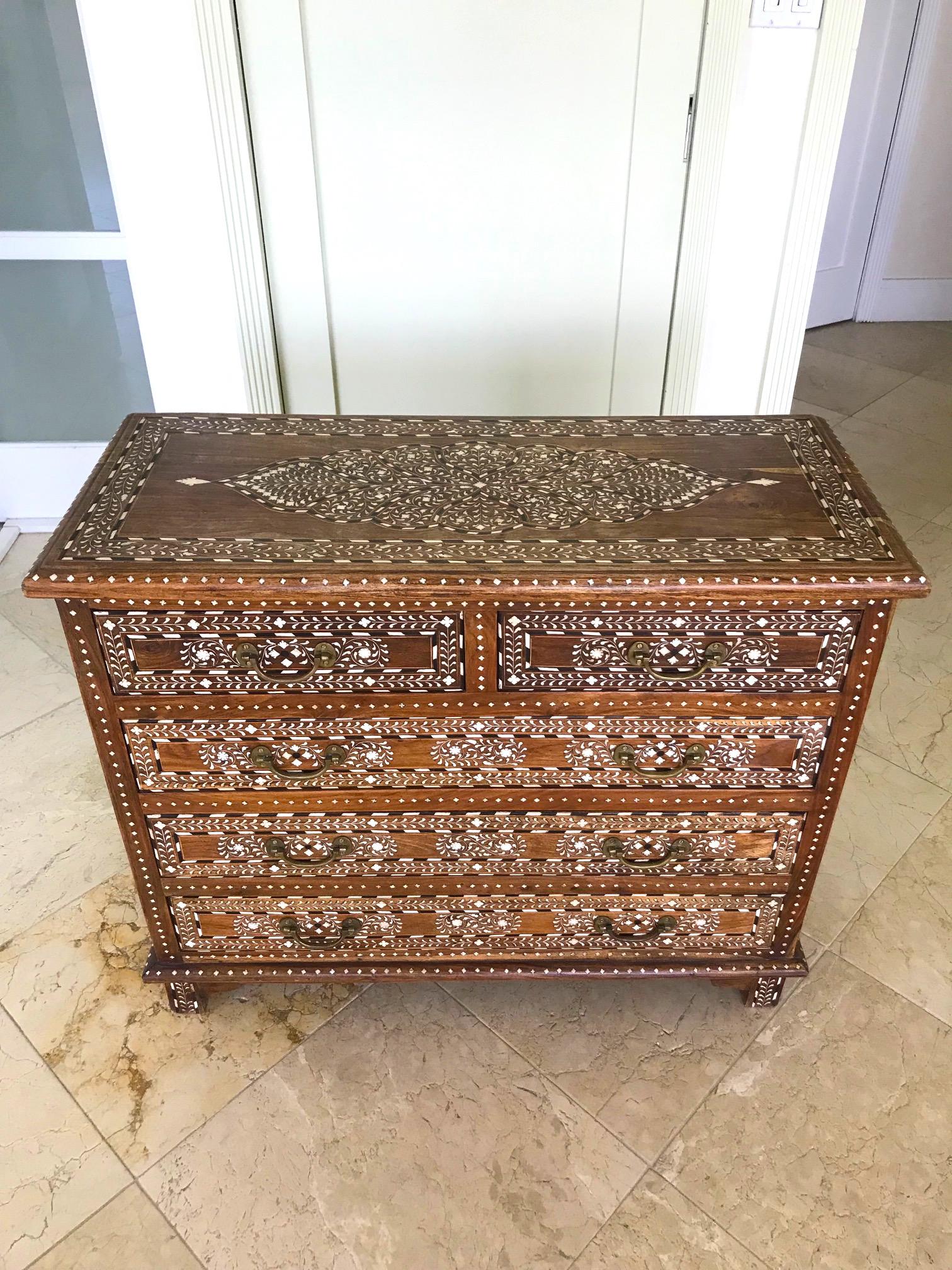 Midcentury Syrian chest of drawers with outstanding series of Moorish designs. All handcrafted by artisans comprised of reclaimed teak wood with bone, mother of pearl, and rosewood inlays throughout. The inlays create intricate geometric and floral