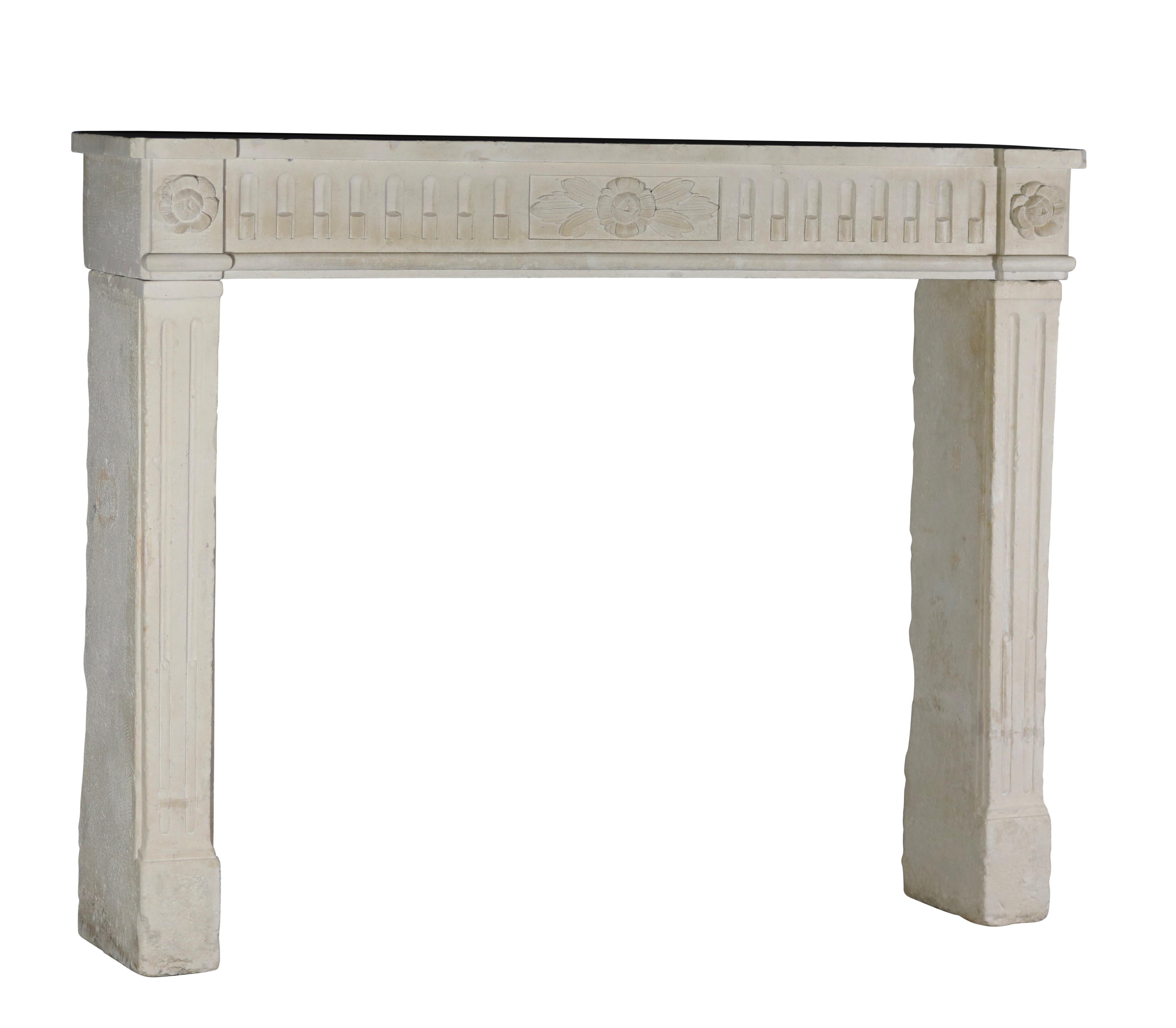 This fine Louis XVI antique fireplace surround in French limestone is in great condition.
Original and one of a kind mantle, a real work of art, with floral details on the front of the 18th century. Original wear and condition. Admire all
