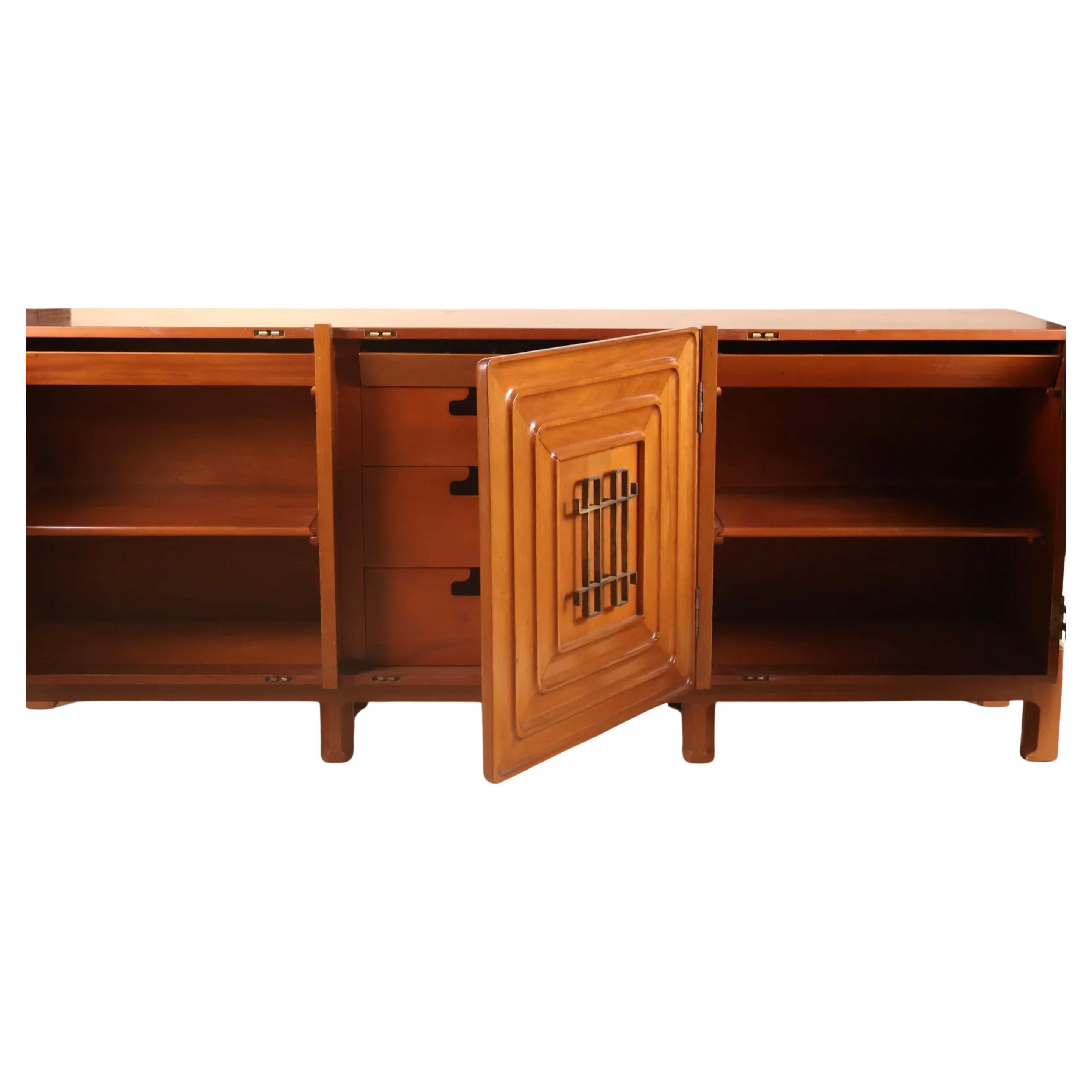This is an extraordinary credenza cabinet or sideboard designed by Swedish designer Edmond J. Spence. This Beautiful piece showcases Spence's exceptional talent and reflects his unique approach to furniture design. Made for Industria Mueblera in