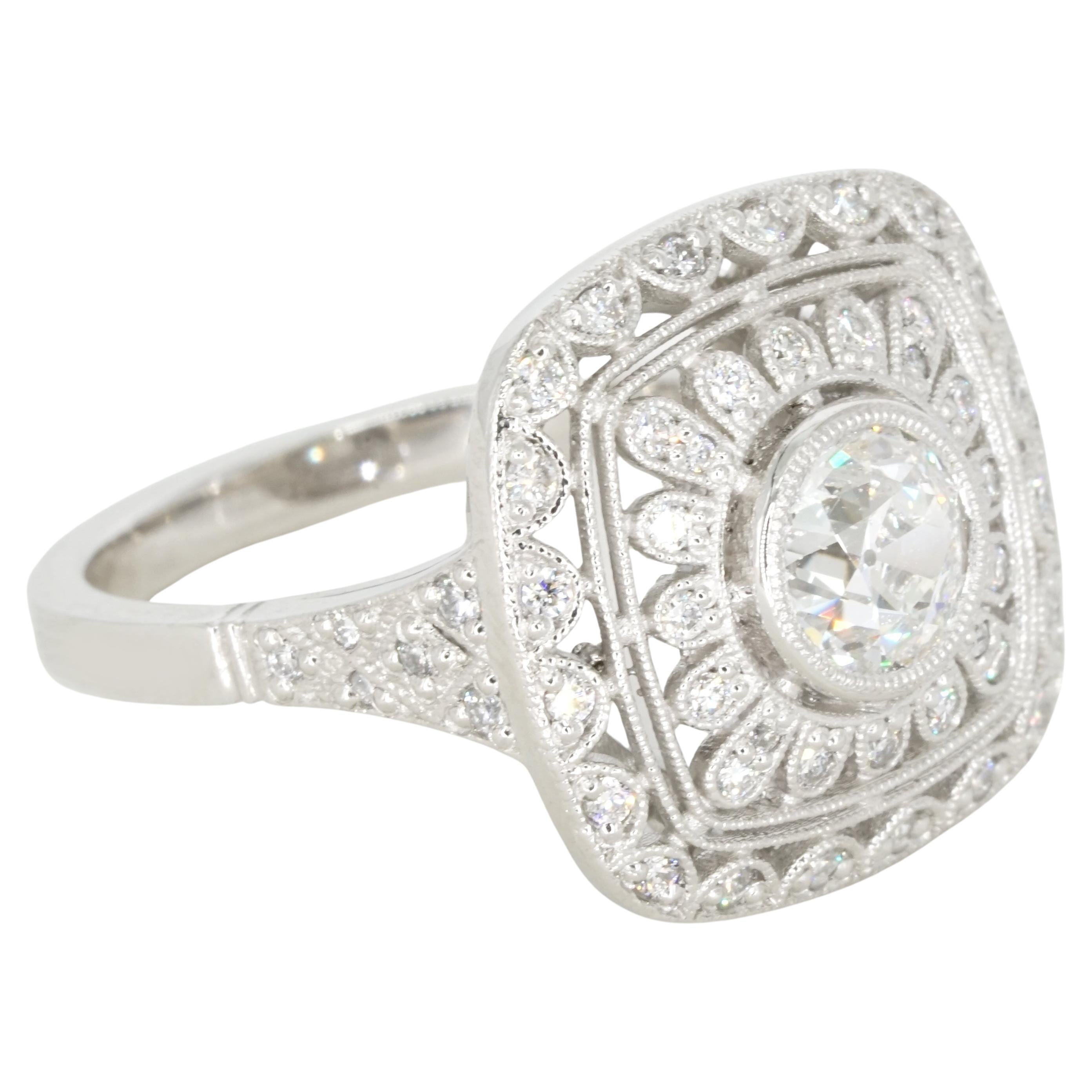Un'accattivante miscela di fascino d'altri tempi e artigianato moderno: questo anello su misura in stile antico presenta un minuzioso design in filigrana in platino (circa 8,82 dwt). Al centro c'è un brillante diamante rotondo, splendidamente