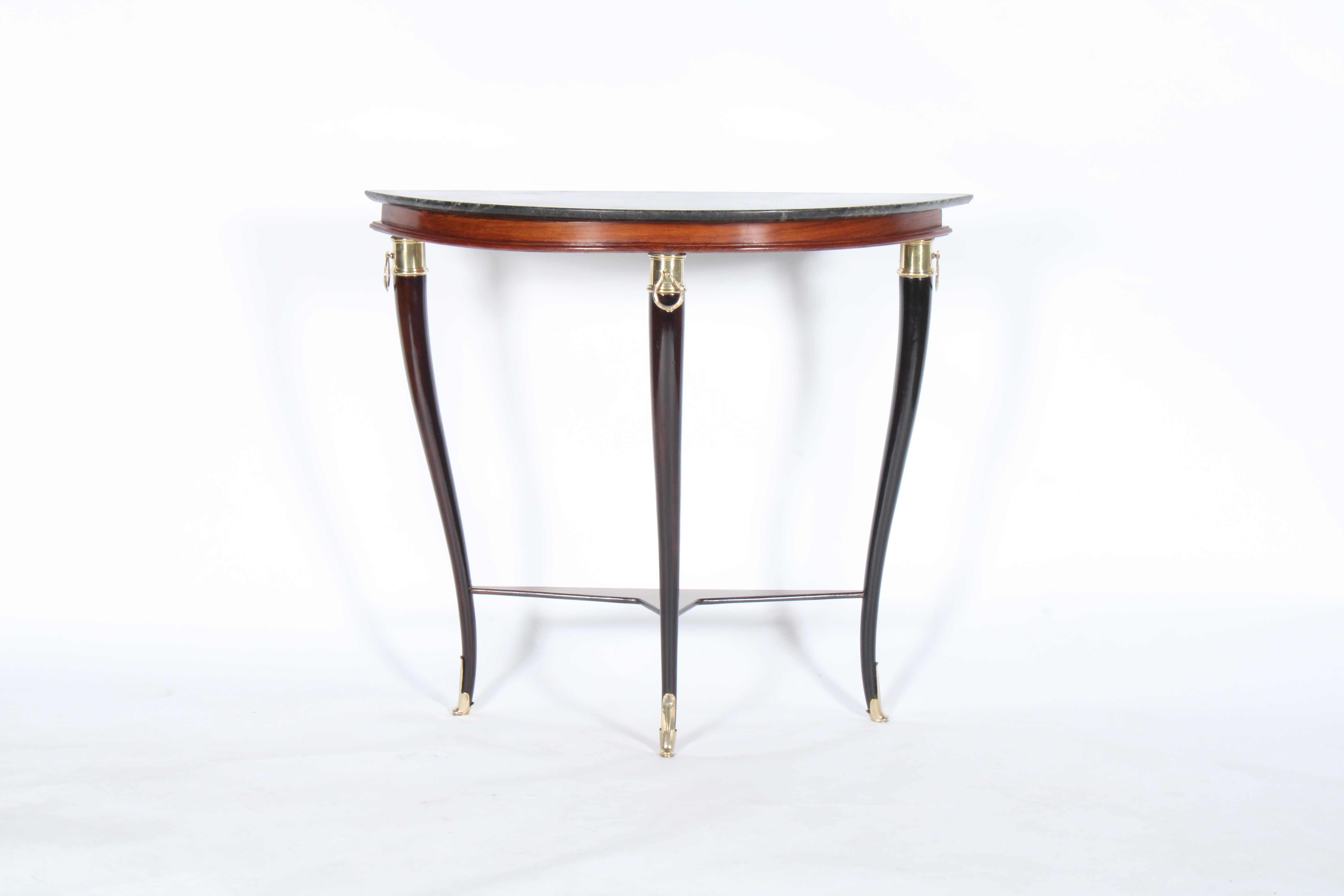 A stunning original mid century Italian console table dating from the 1950's in the style of Paola Buffa. WIth elegant ebonised saber legs, inset marble top and brass detailing this piece oozes style and class. A combination of neo classical