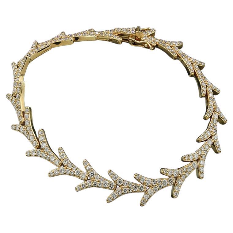 A modern luxurious bracelet , fully adorned with 240 round brilliant-cut diamonds, together approx. 3.62 carats. Color: F-G, Clarity: VS-I1. The bracelet features links in a curved Y-shape, connected with hinges on the sides and downward. It is