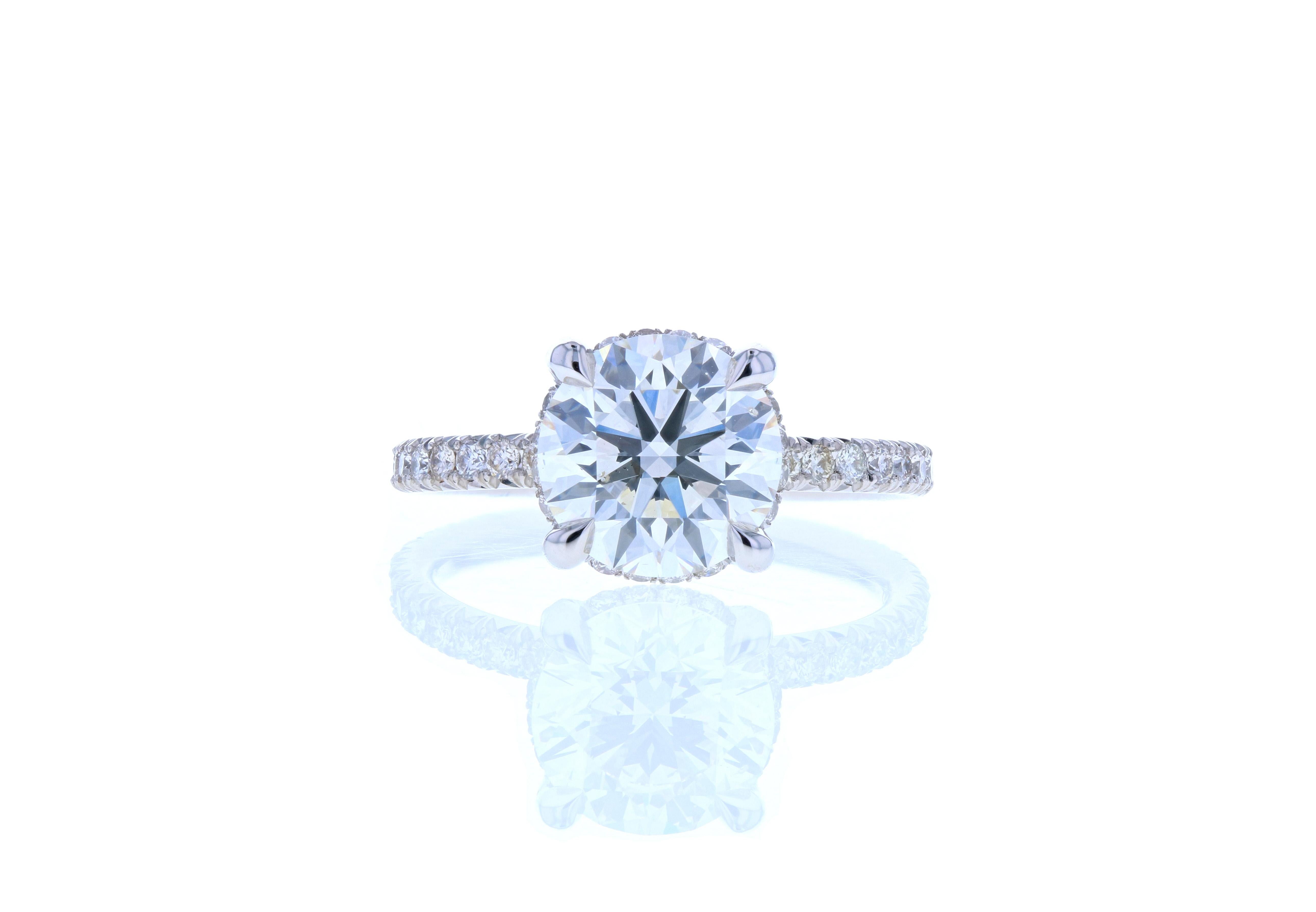 This diamond and platinum engagement ring is a diamond lover’s dream! With 3/4 French cut pave, diamonds on the legs, a  hidden halo, eagle claw prongs and a STUNNING center stone, this ring is a masterclass in crafting an heirloom quality