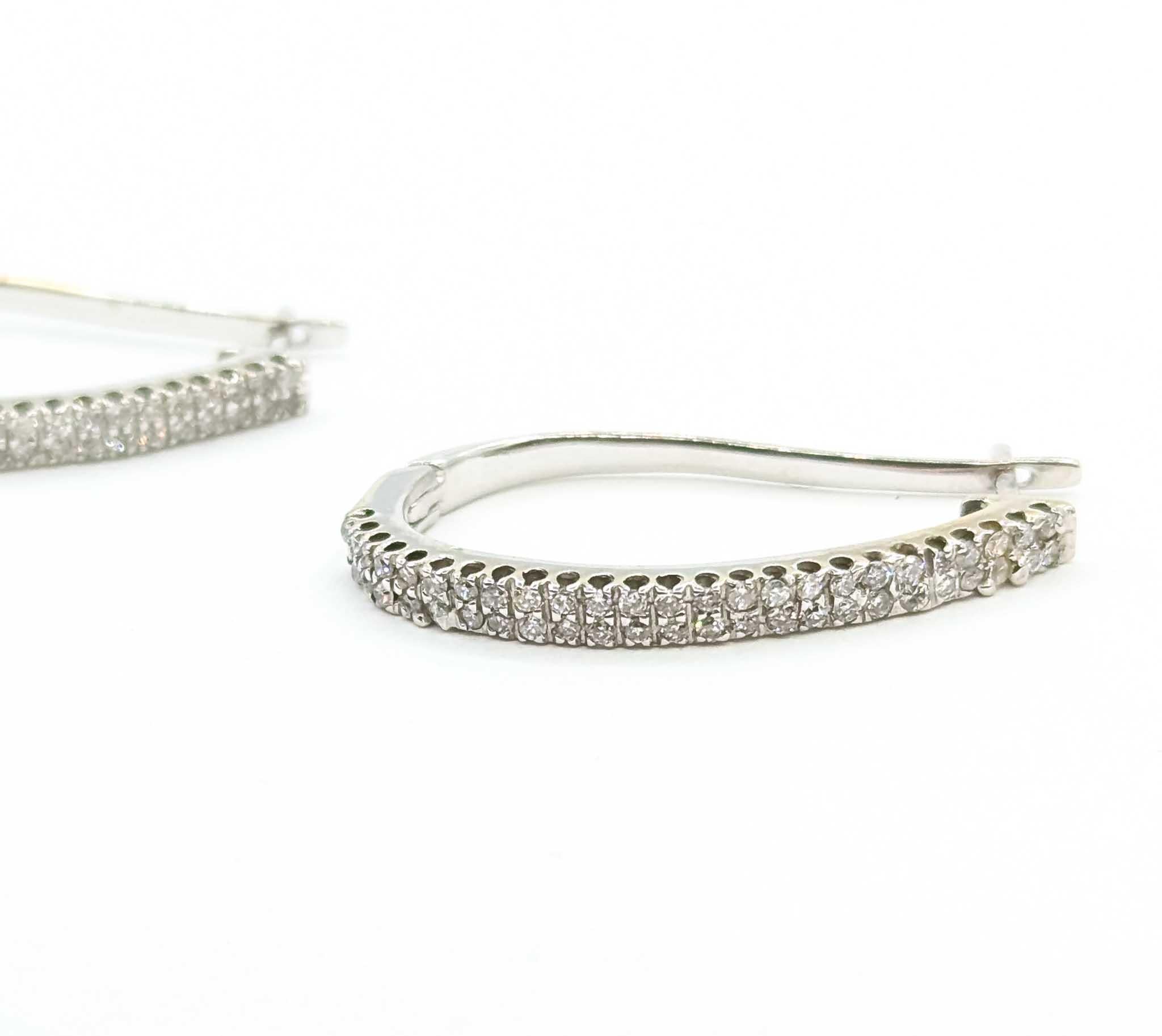 Exquisite Diamond Half Hoop Earrings in 14k White Gold

Introducing these exquisite diamond half hoop earrings, meticulously crafted in 14k white gold with a sophisticated lever back design. The earrings showcase a stunning array of diamonds