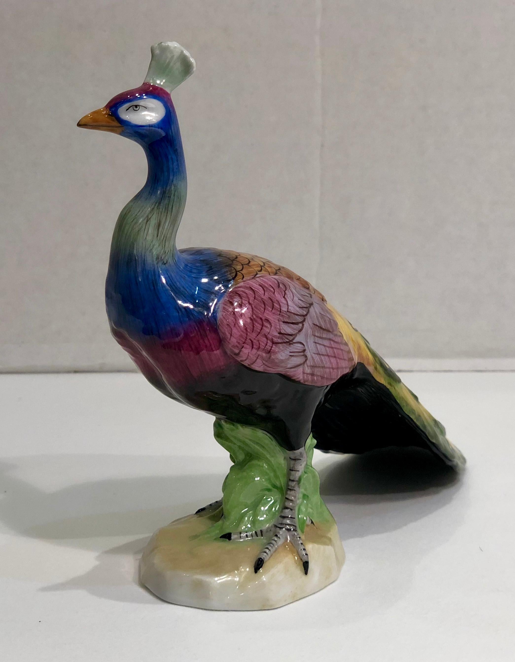 Handmade, hand painted, collectible estate figurine from Dresden Porcelain in Germany is a brightly colored, beautifully sculpted, proud male peacock who is facing forward, with his tail closed. This figurine is currently in production and retails