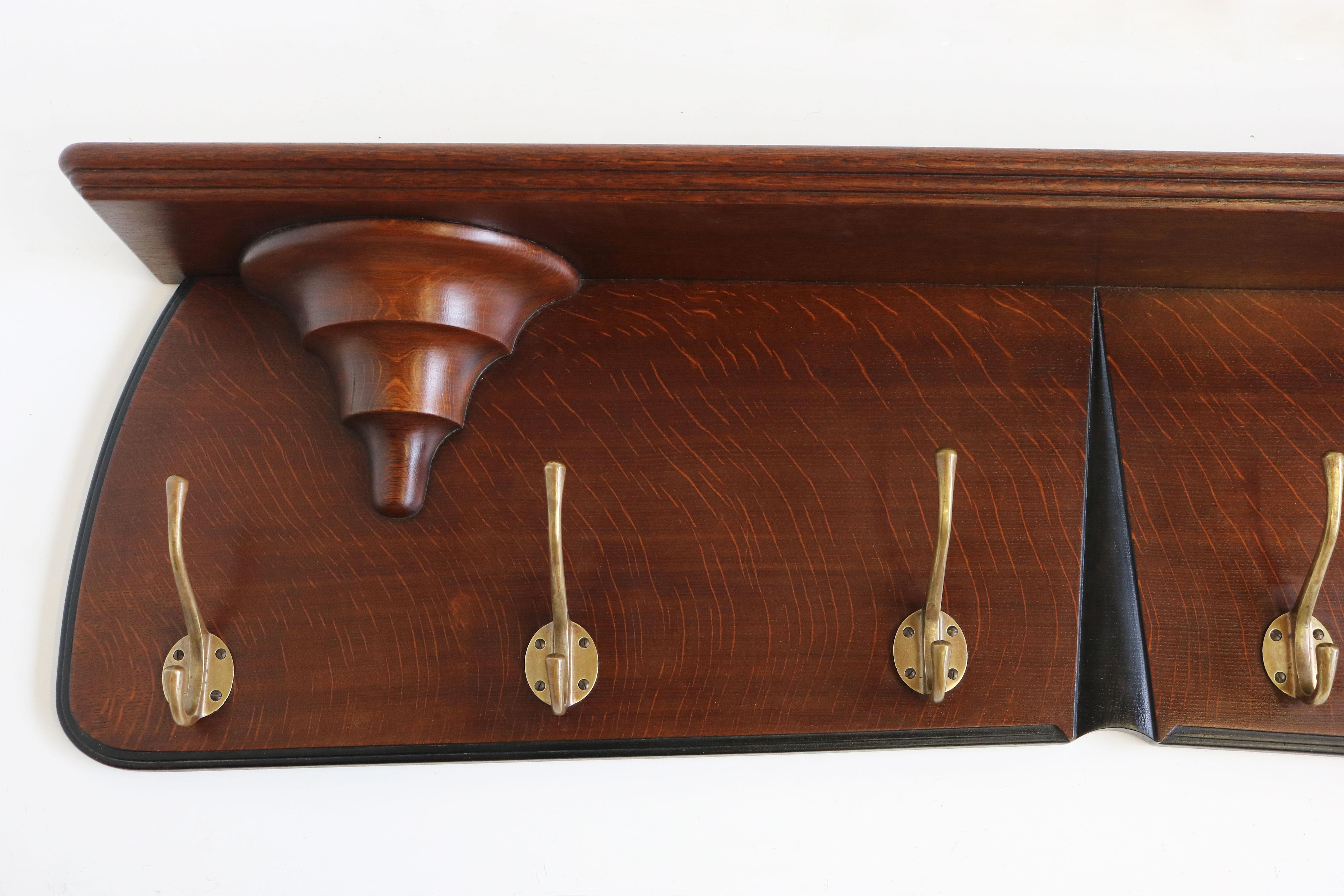Exquisite & Timeless! This Dutch design Art Deco Amsterdam school style Coat rack by Hildo Krop.
Hildo Krop is one of the most famous Amsterdam school designers and this coat rack perfectly displays why. 
The use of the tiger oak combined with the