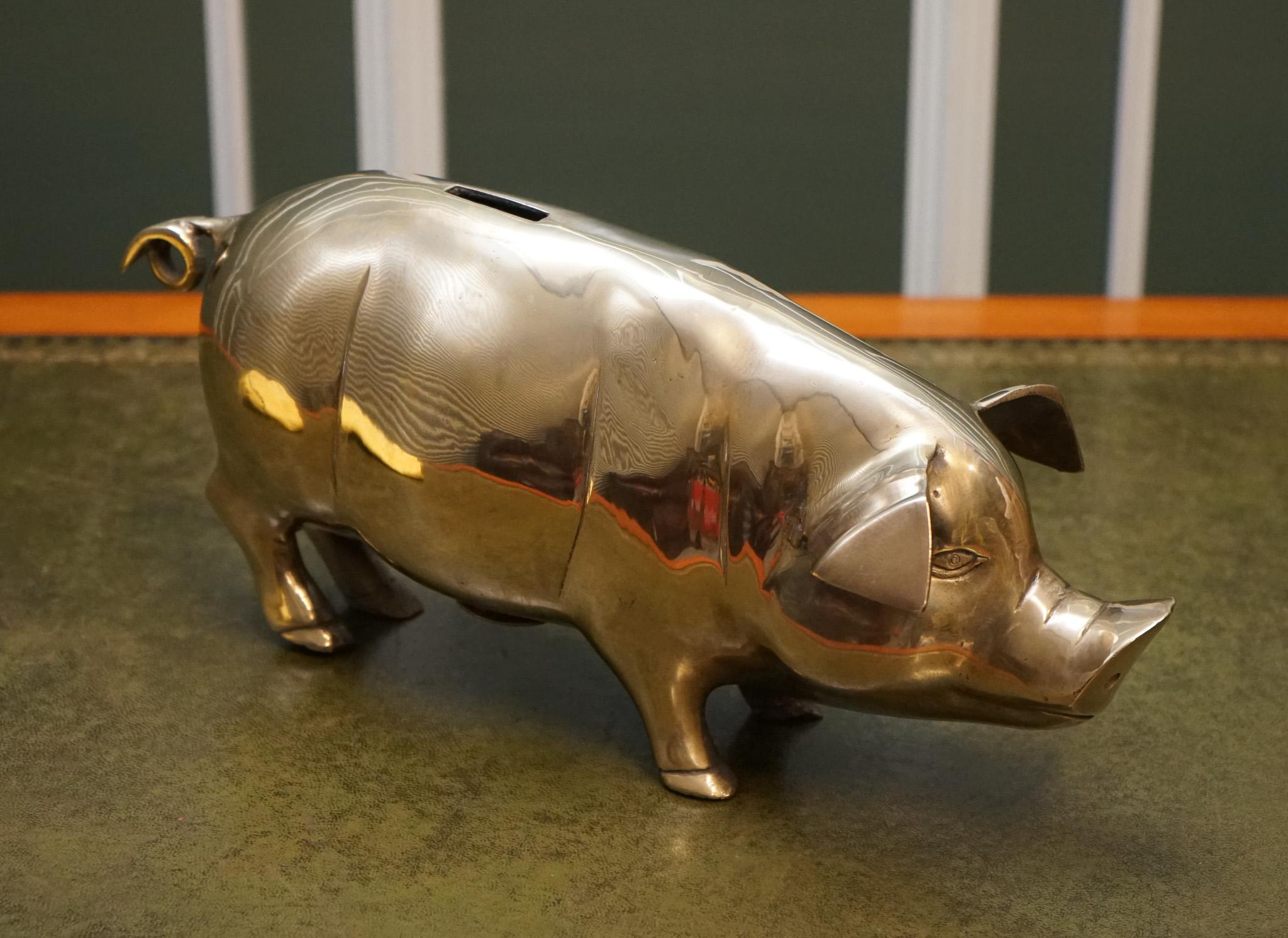 
We are delighted to offer for sale this Lovely 1920s Antique Brass Piggy Bank.

 The piggy bank would resemble an actual pig with all the features that the animal has, such as ears, snout, curly tail, and four hoofs. 
The brass used is of high