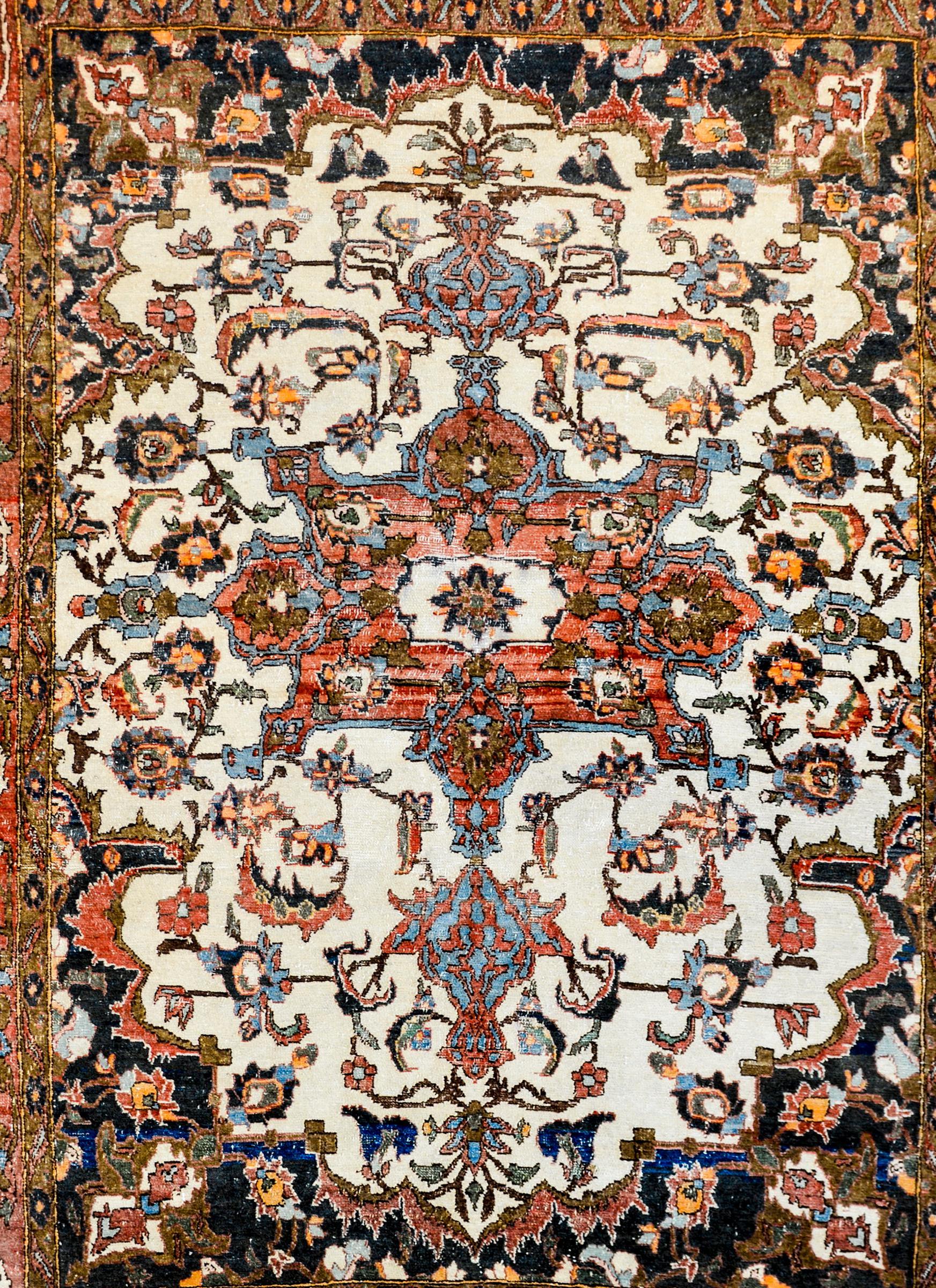 An exquisite early 20th century Persian Malayer rug with an extraordinary all-over trellis pattern with scrolling vines and large-scale flowers woven in crimson, light and dark indigo, gold, pink, and green vegetable dyed wool. The border is