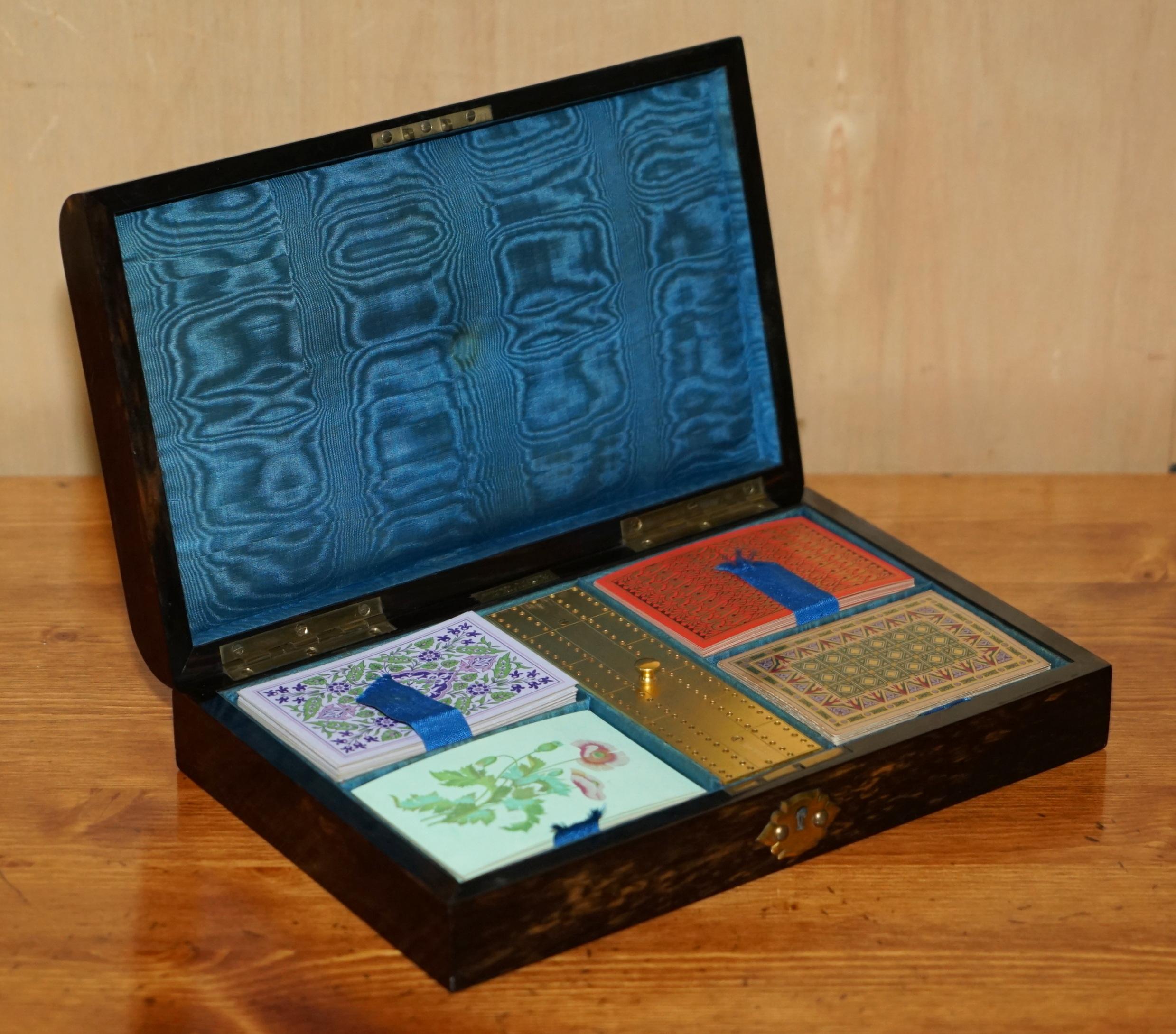 Royal House Antiques

Royal House Antiques is delighted to offer for sale this absolutely stunning, Museum Quality, near new old stock circa 1850 Edward & Jones of 161 Regent Street London, Coromandel wood and brass mounted cribbage set with NOS De