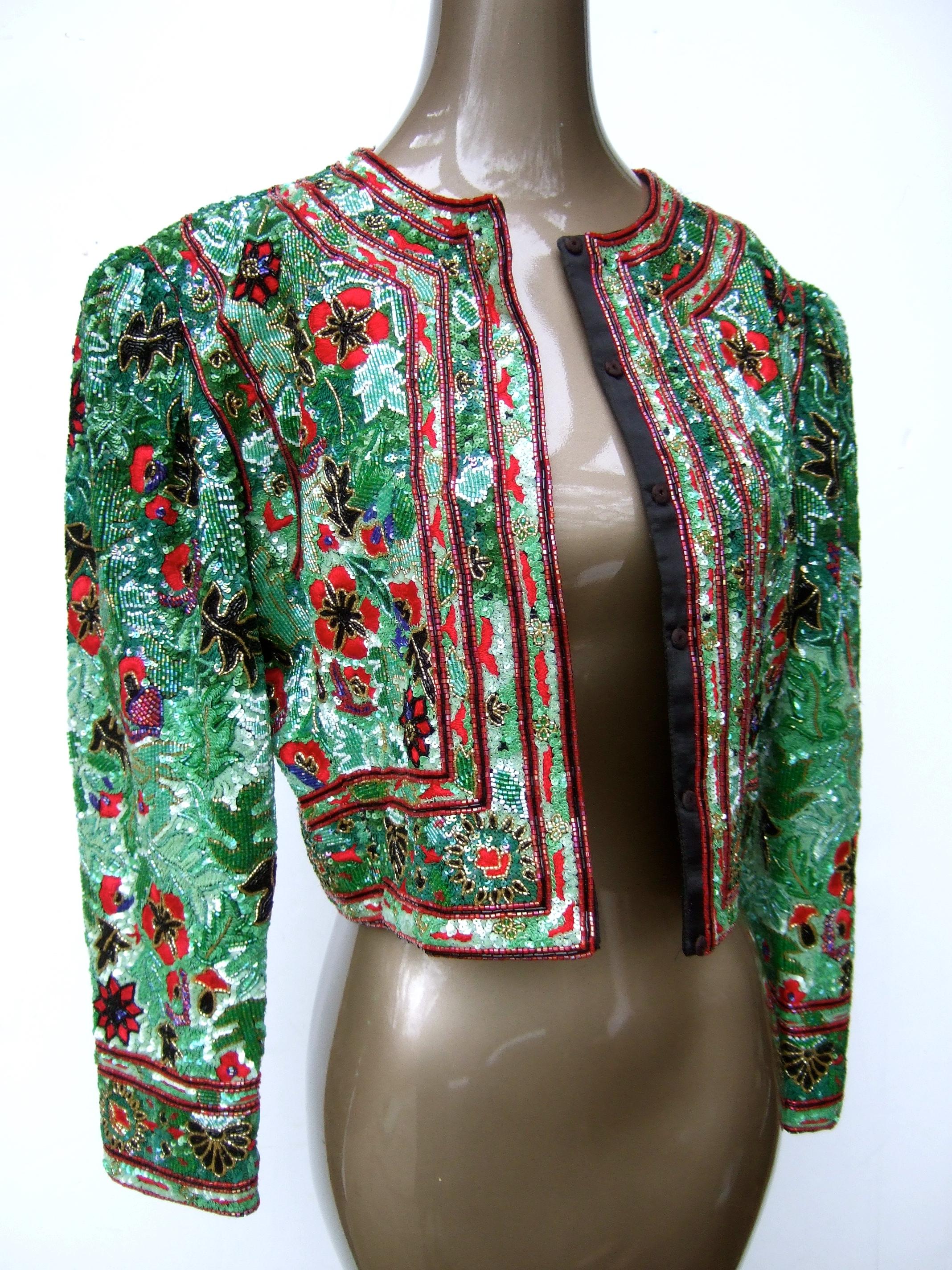 Exquisite heavy glass floral beaded embroidered bolero jacket c 1980s
The opulent glass beaded jacket is encrusted with elaborate 
hand beading accented with embroidered flowers throughout

Makes a stunning formal wear garment 
The shoulder sleeves