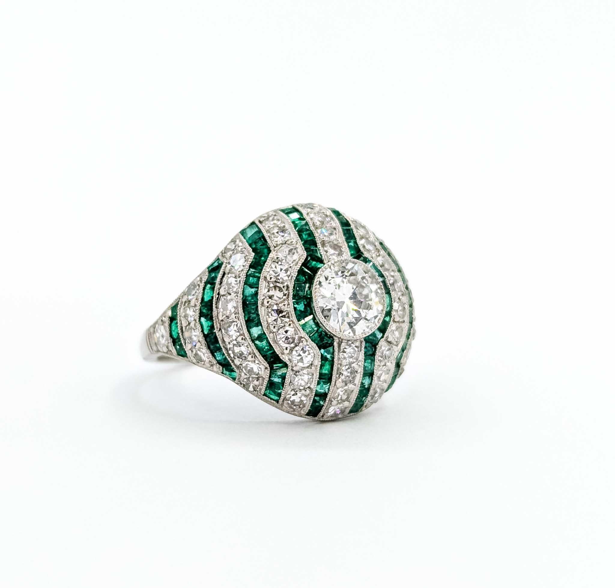 Exquisite Emerald and Diamond Platinum Ring

Introducing this exquisite vintage ring, masterfully crafted in luxurious platinum. This captivating piece showcases a stunning array of gemstones, including a .61-carat diamond at its center, surrounded