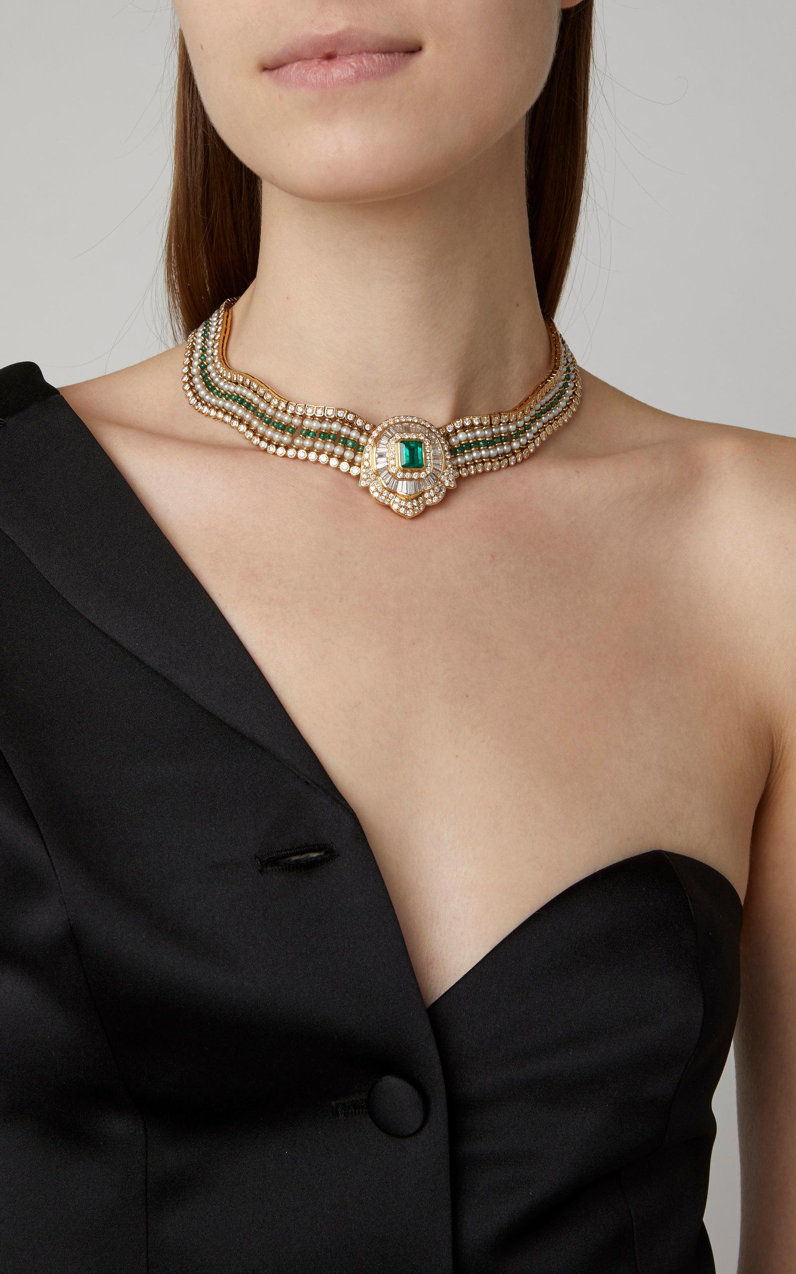 An exquisite necklace of undulated design, with emeralds, diamonds, and pearls, the central emerald weighing 4.5 carats, while the diamonds 25 carats total, mounted on 18kt yellow gold. Made in Italy, circa 1965.