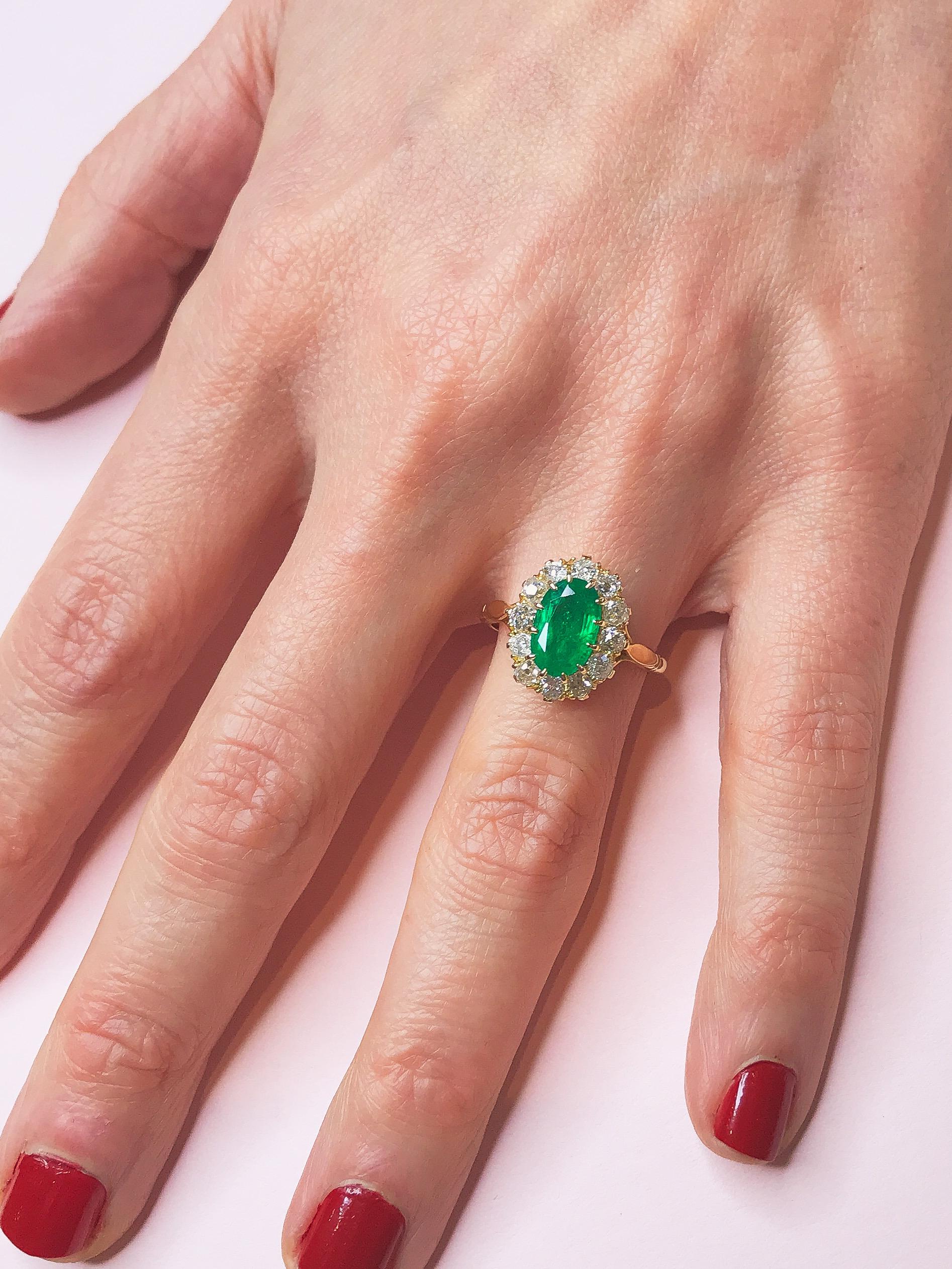 Handmade by the Haruni family, this bright and bold ring is truly one of a kind. Its centre emerald is an intense, rich green and is cut in a classic oval shape. Small brilliant cut white diamonds are mounted around it, enhancing its colour and