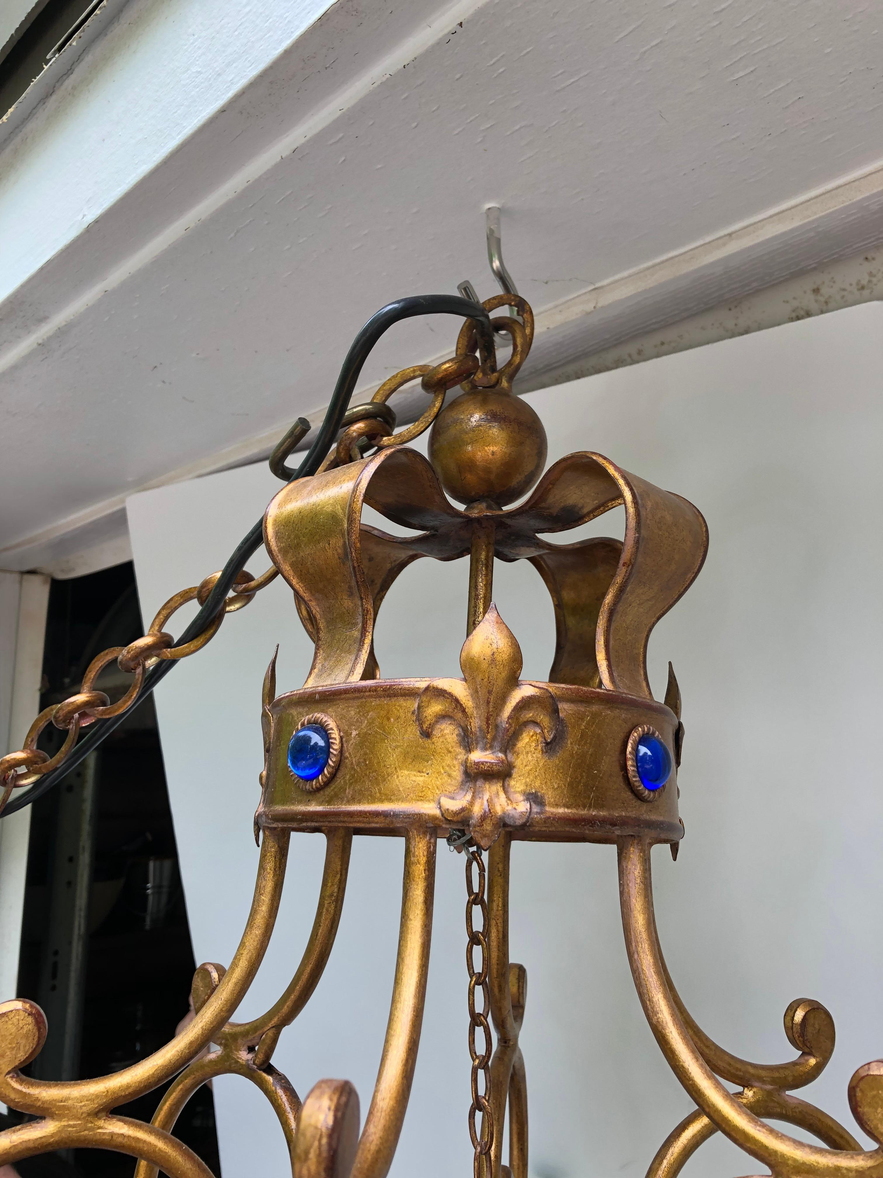 Beautiful giltiron 6 arm chandelier having an English regal vibe with bejeweled crown 
