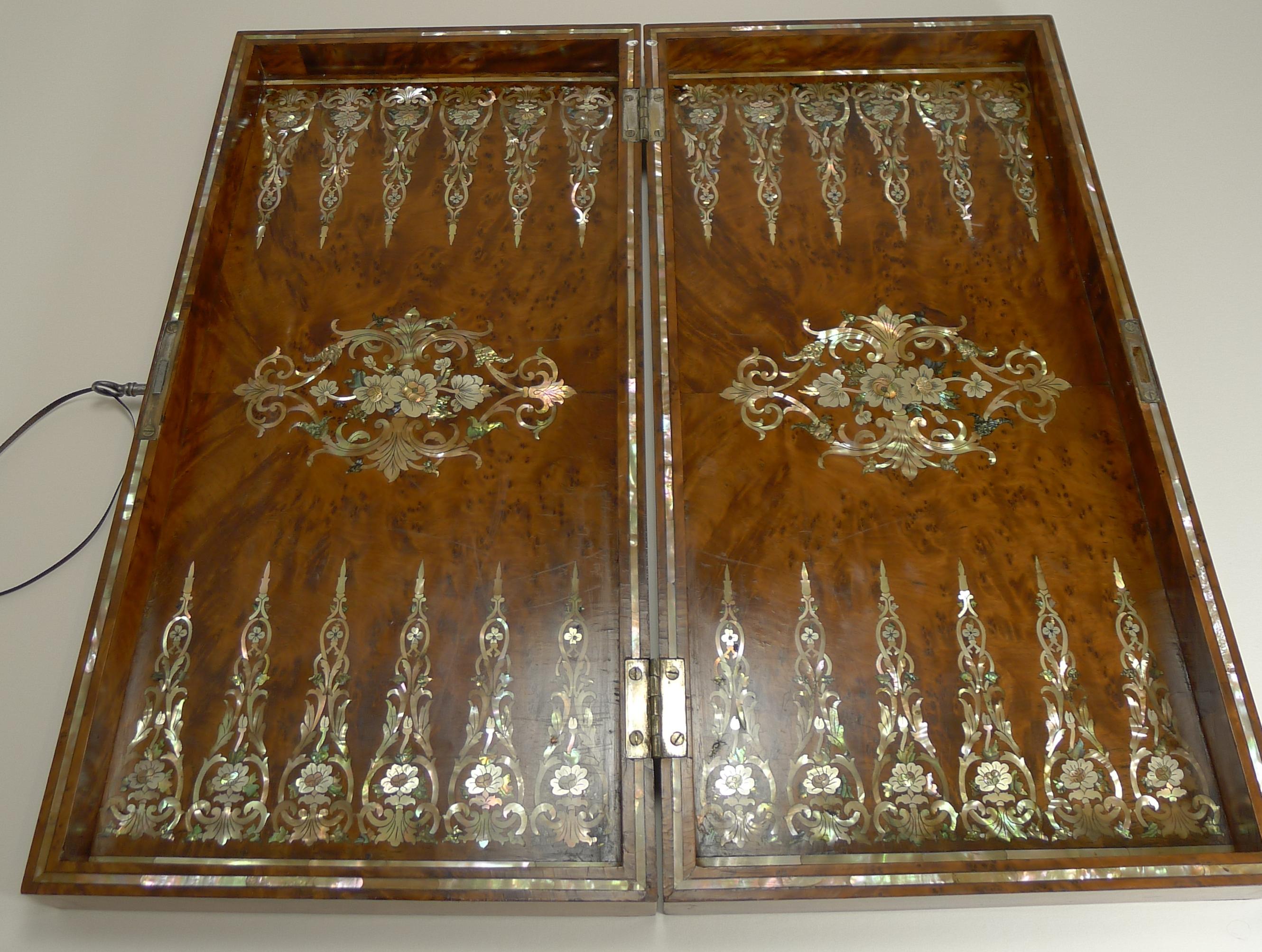 A fabulous and scarce Backgammon board made from highly prized Amboyna wood, the most precious and expensive timber in the world, sought for it's tight curly grain and rich cognac color.

Of course it is the intricate and highly decorative Mother