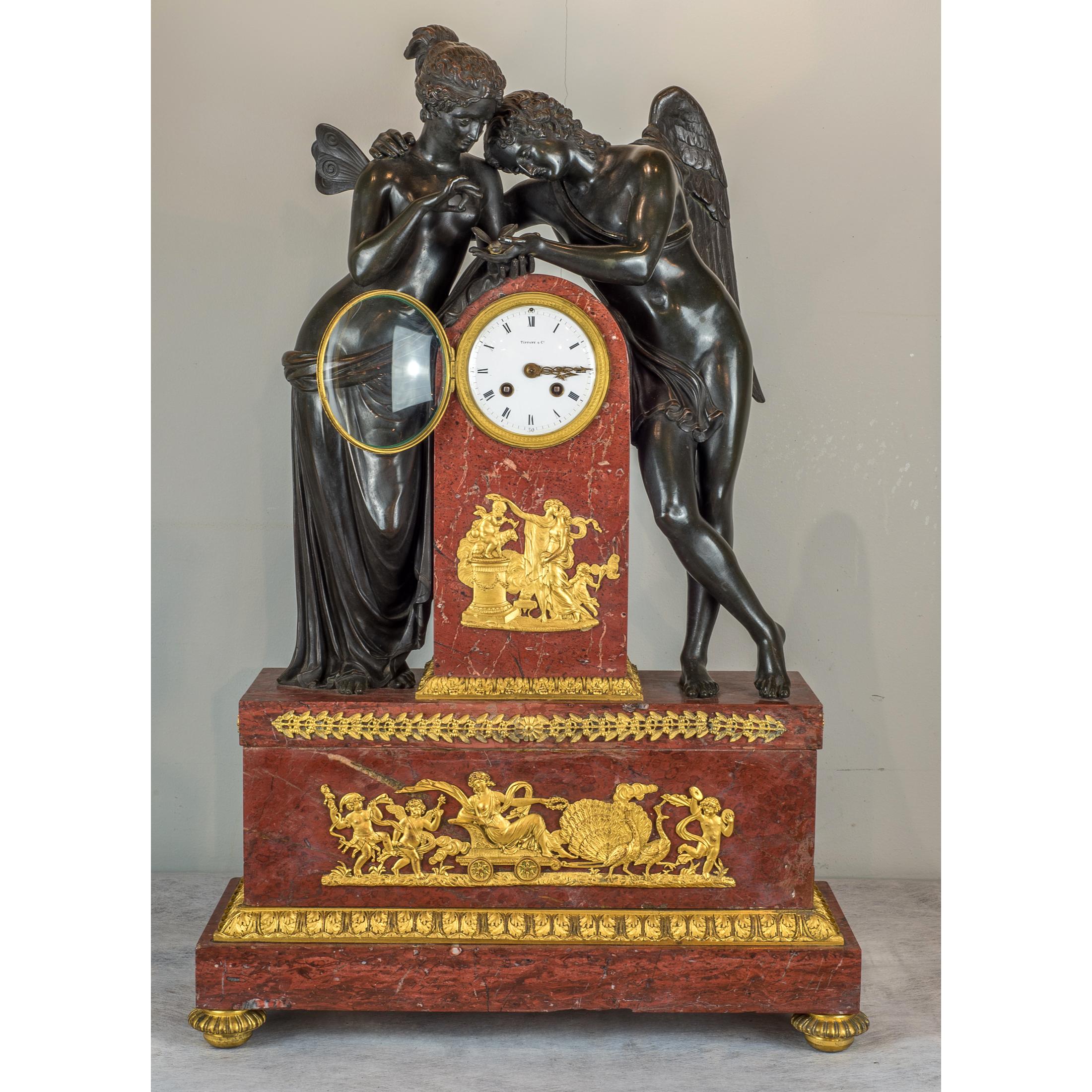 A fine quality Napoleon III gilt and patinated bronze and rouge marble.
Figural mantel clock depicting amor and psyche with butterfly. The dial marked 