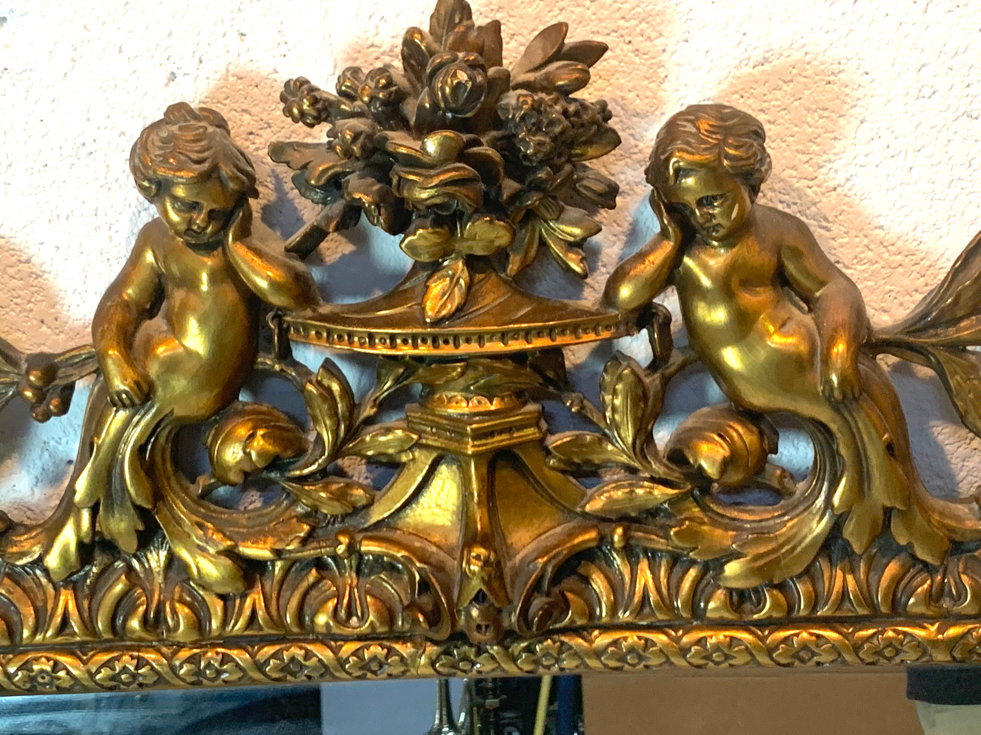 Beveled Exquisite French Carved Giltwood Putti Motif Cushioned Mirror, Paris, 1900