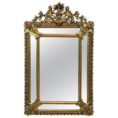 Antique Exquisite French Carved Giltwood Putti Motif Cushioned Mirror, Paris, 1900