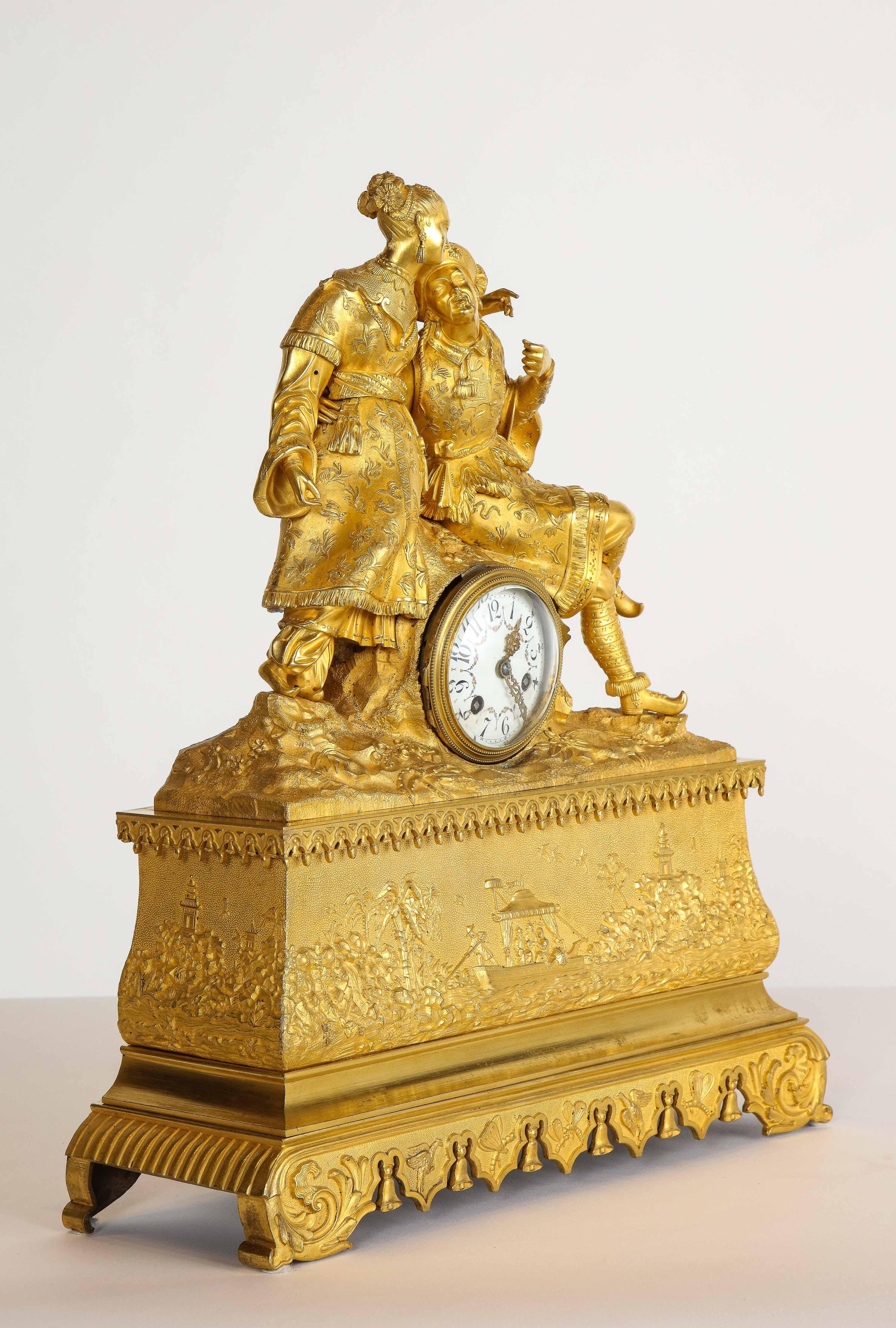 Exquisite French Charles X ormolu bronze chinoiserie figural table clock, early 19th century.

Depicting a Chinese, man and woman. The clock case depicting the China trade.

Very high quality ormolu. Very fine chasing. Fully detailed