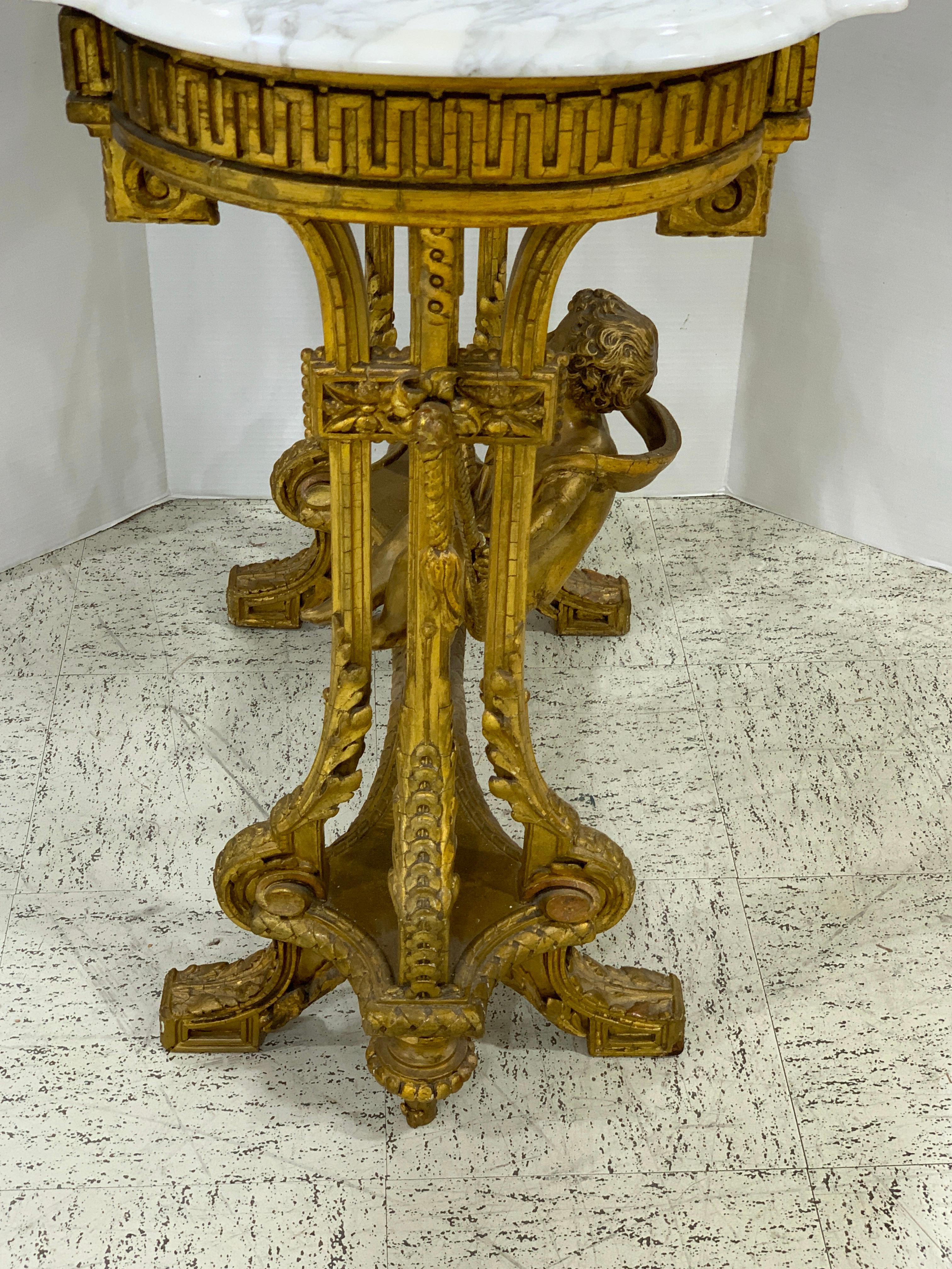 Metal Exquisite French Giltwood Swinging Putto Marble Top Table/ Ferner For Sale