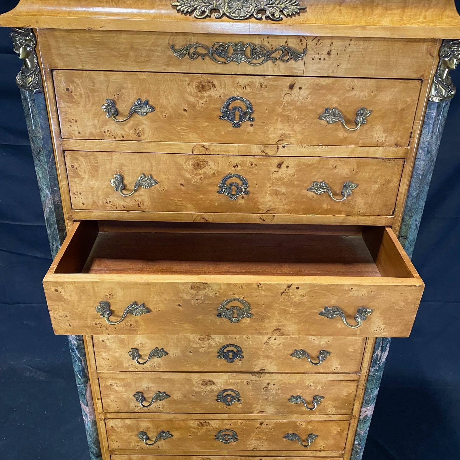 A French Louis XVI style lingerie or linen chest from the early 20th century having a semainier (or semaniere) design of eight drawers, typically used for storing lingerie or linens. The top of the burled walnut chest is a beautiful forest green