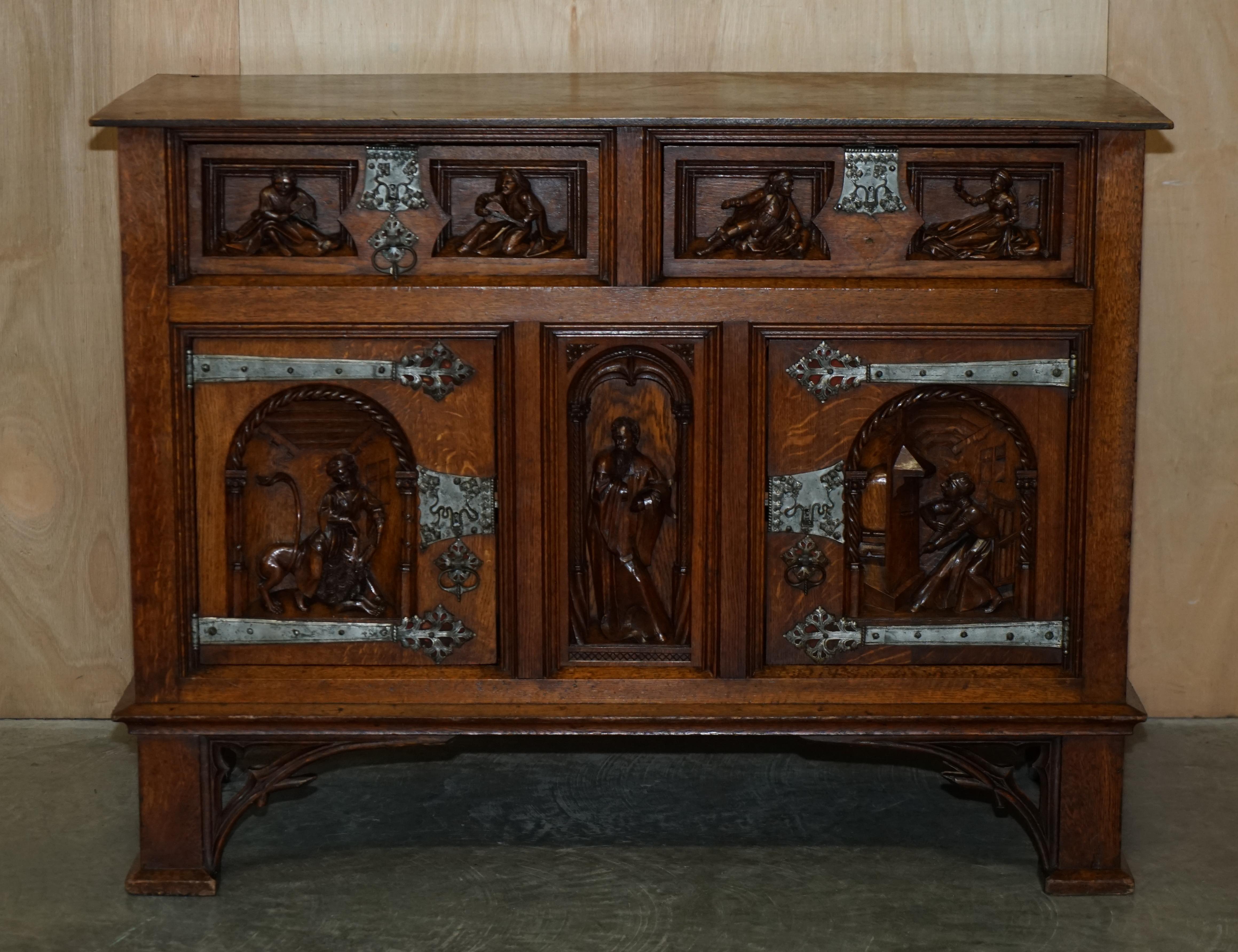 We are delighted to offer for sale this very rare and highly collectable, circa 1860 Gothic revival hand carved English oak sideboard 

A very good looking and decorative piece, it is heavily hand carved depicting courting couples and so on, most