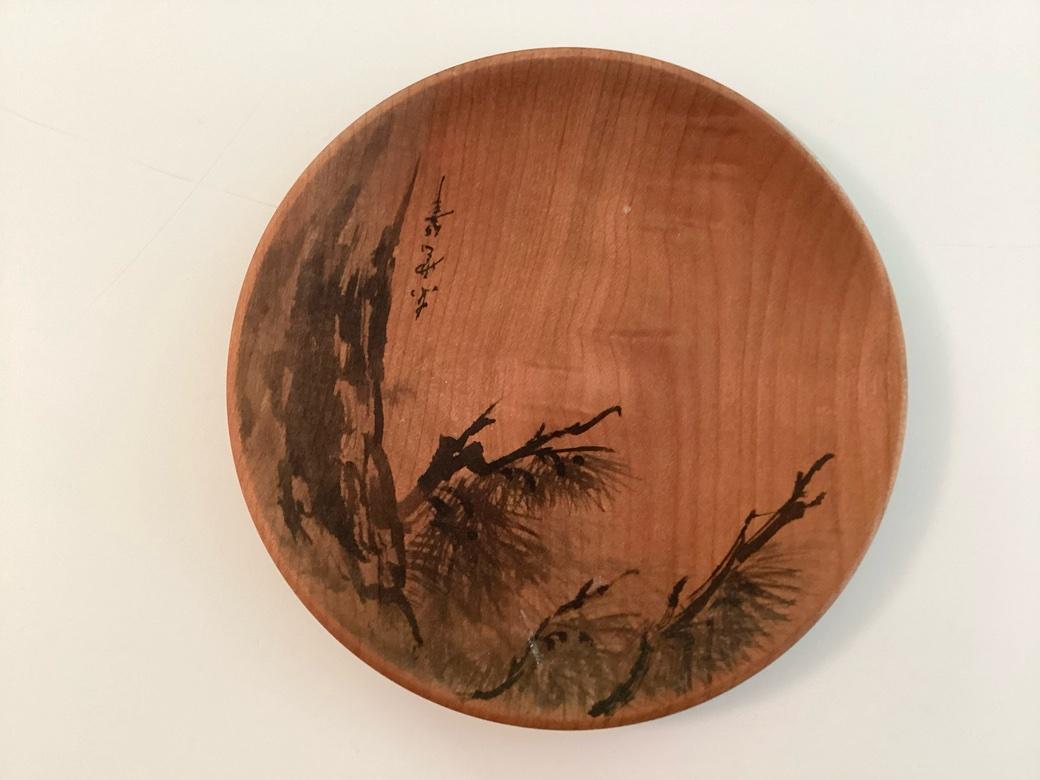 A superb group of five well crafted and finished Pine dishes with hand illustrated images of Pine, Bamboo, Chrysanthemum, Plum and Iris done in black ink with various Japanese script (possibly poems) and red ink chop marks. The wood graining is