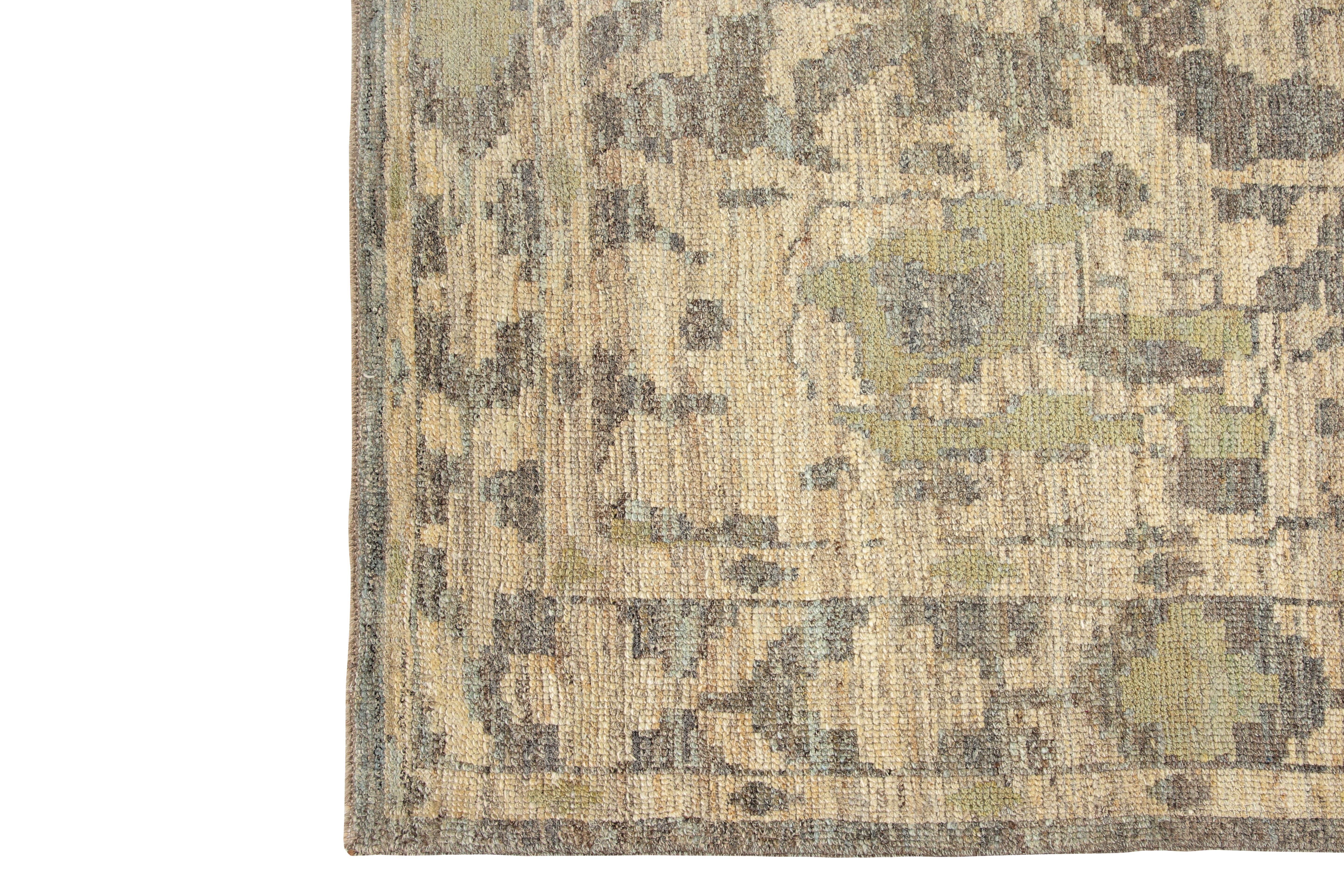 Introducing our exquisite handmade Oushak rug, originating from Turkey. This stunning rug boasts a light grey background with a beautifully blended beige border, adding a touch of elegance to any room. The modern design incorporates tones of green,