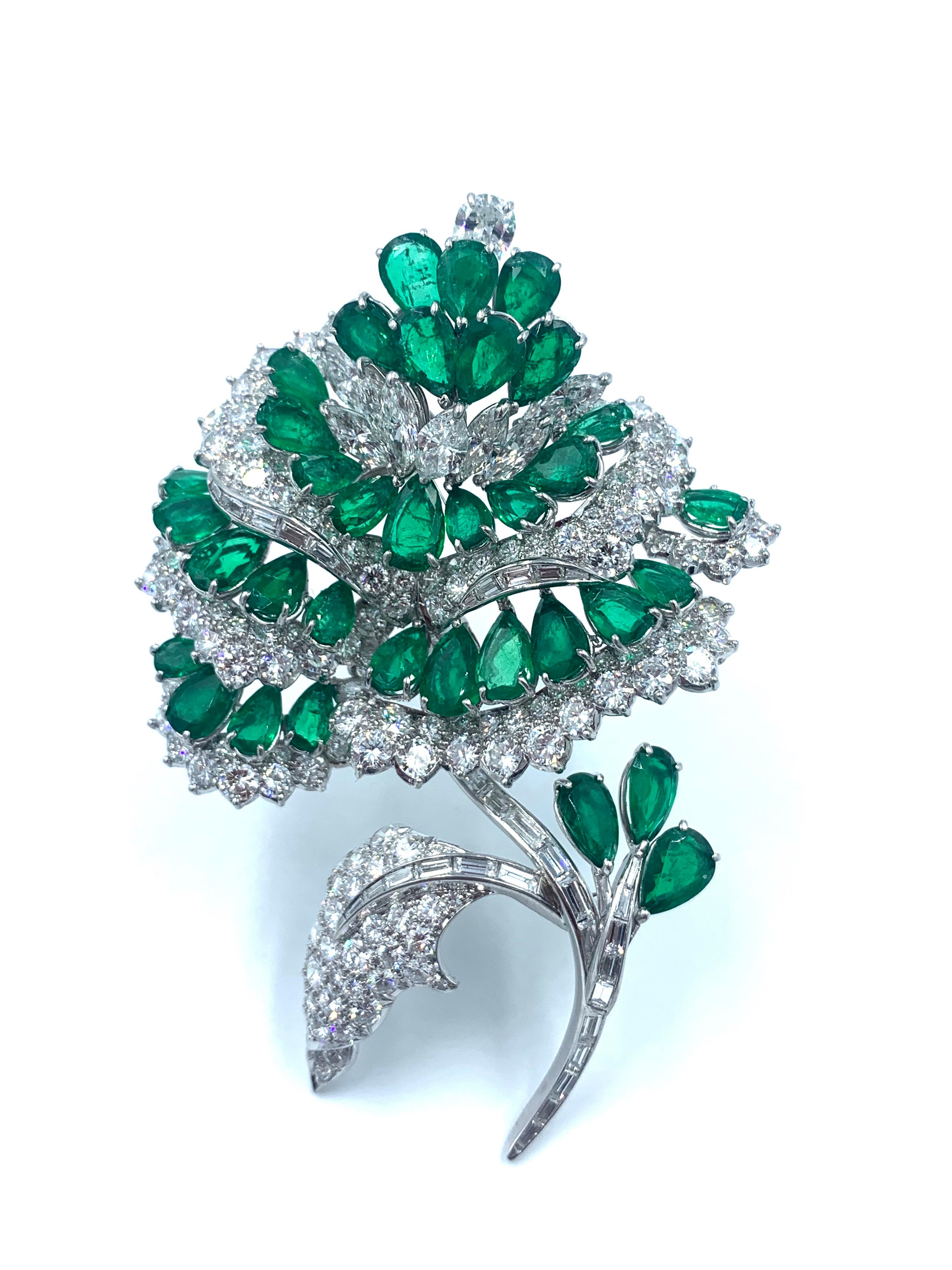 A fabulously elegant, handmade platinum diamond and emerald flower brooch. Beautifully crafted In the shape of a flower and set with 24 carats of diamonds. From the back, the diamonds are set in a beautiful honeycomb pattern. 28 carats of fine pear