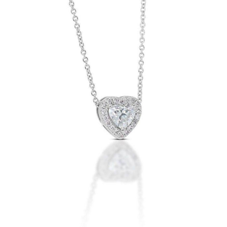 A captivating 0.72 carat heart-shaped diamond, ablaze with the near-colorless fire of G grade and VS2 clarity, takes center stage, its every facet whispering tales of love and brilliance. An EX-cut masterpiece, certified by the prestigious GIA and