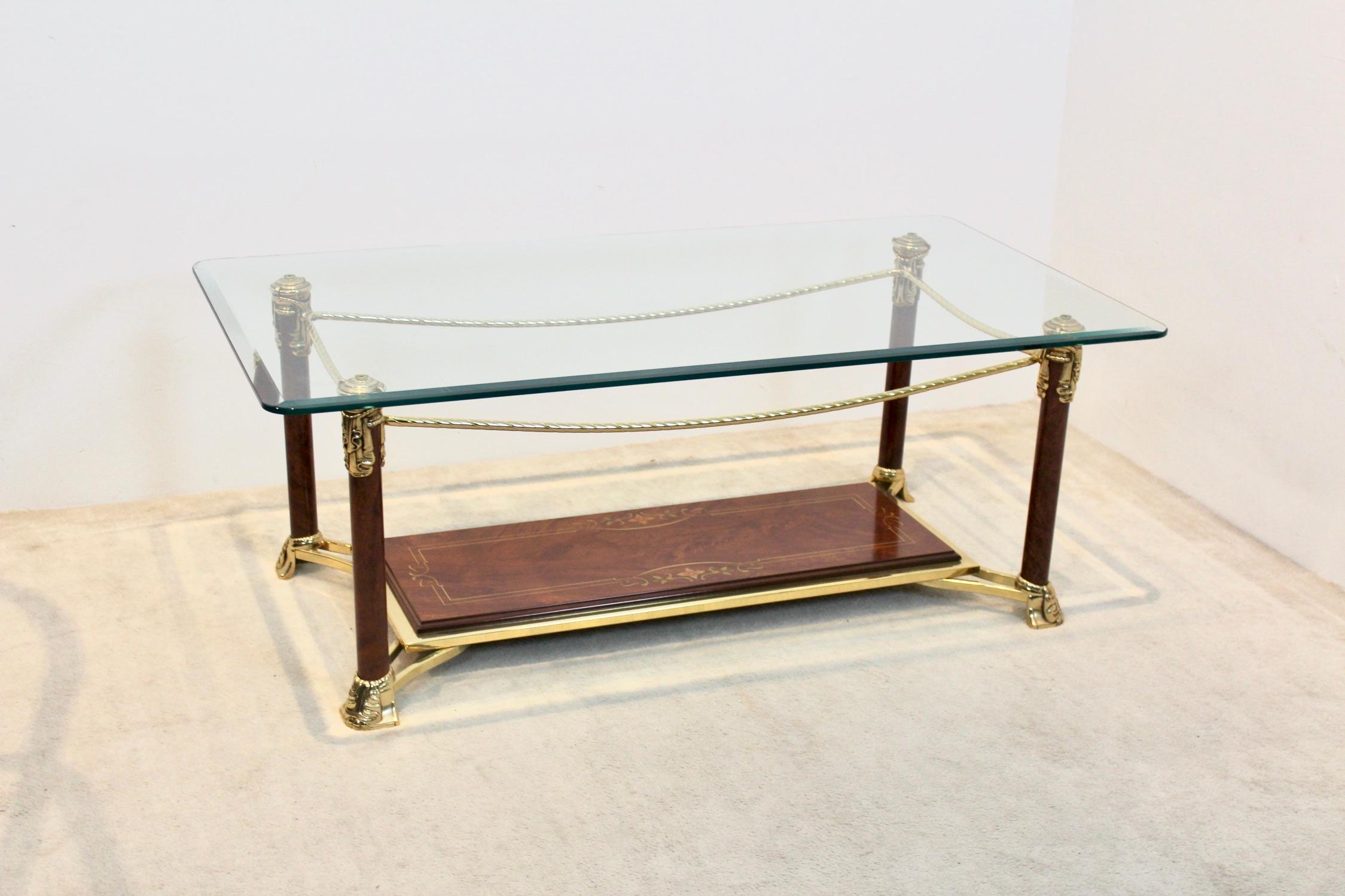 A truly beautiful brass and burr walnut coffee table with a solid glass top. In true Hollywood Regency manner this elegant Hollywood Regency style table has a unique cut-out rectangular design. Produced in France, circa 1970s. In very good