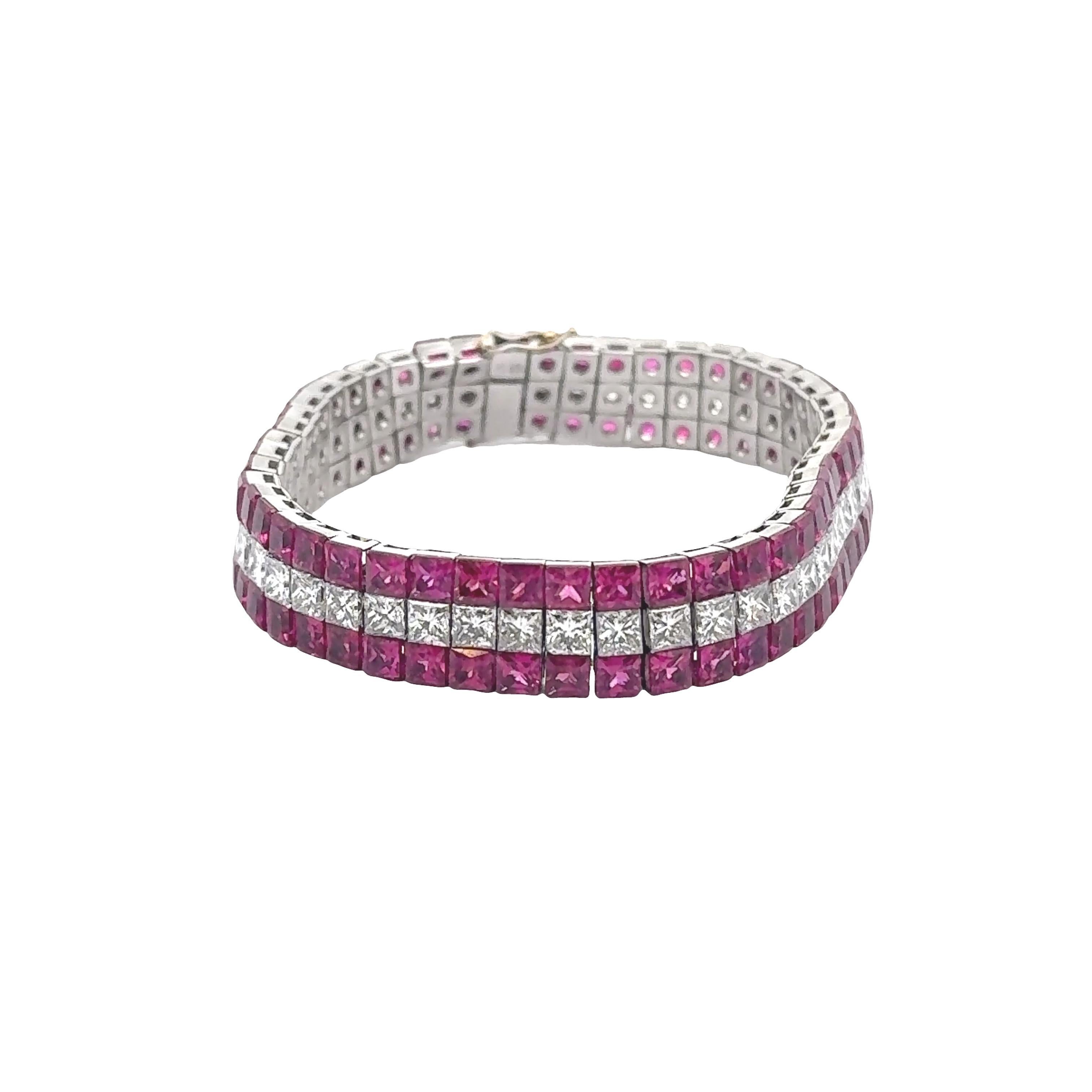 A contemporary creation from the 21st century, this platinum bracelet showcases a captivating array of square rubies, each uniform in size and displaying a rich red hue, totaling approximately 24.50 carats. Complementing the rubies are princess