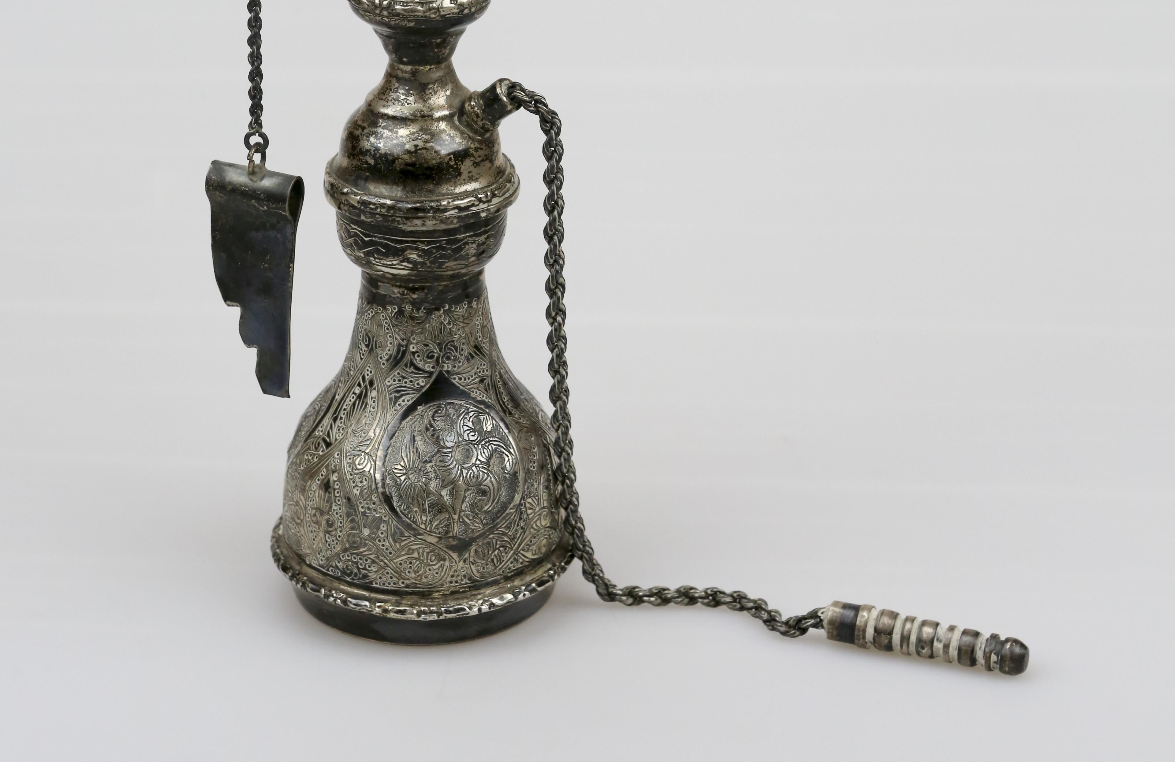 Introducing a truly captivating piece of art, the Persian Silver Miniature Decorative Hookah. This exquisite hookah is a masterpiece crafted by skilled artisans from Iran, renowned for their unparalleled craftsmanship and attention to