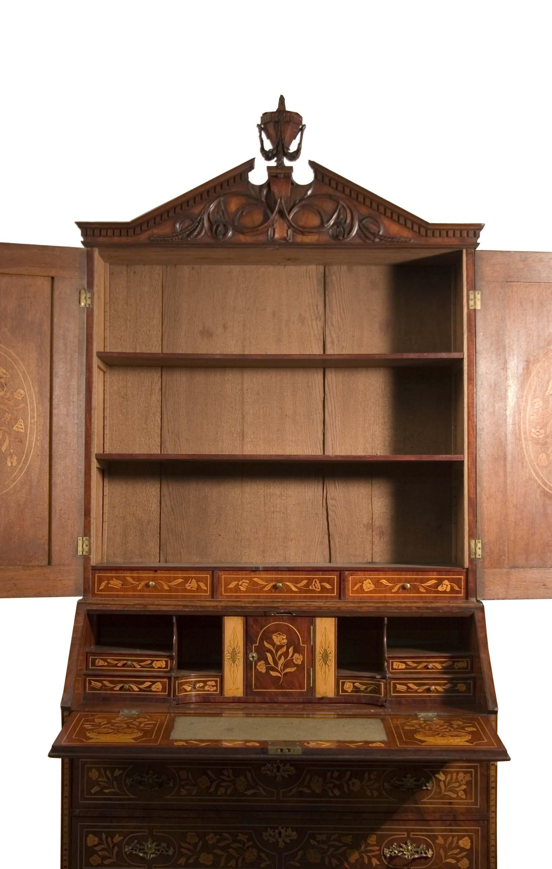 Exquisite mahogany feathered trumeau, richly adorned with polychrome floral inlays typical of Dutch craftsmanship. The lower part is divided into three large drawers and two small drawers that support the drop-front, decorated with inlays depicting