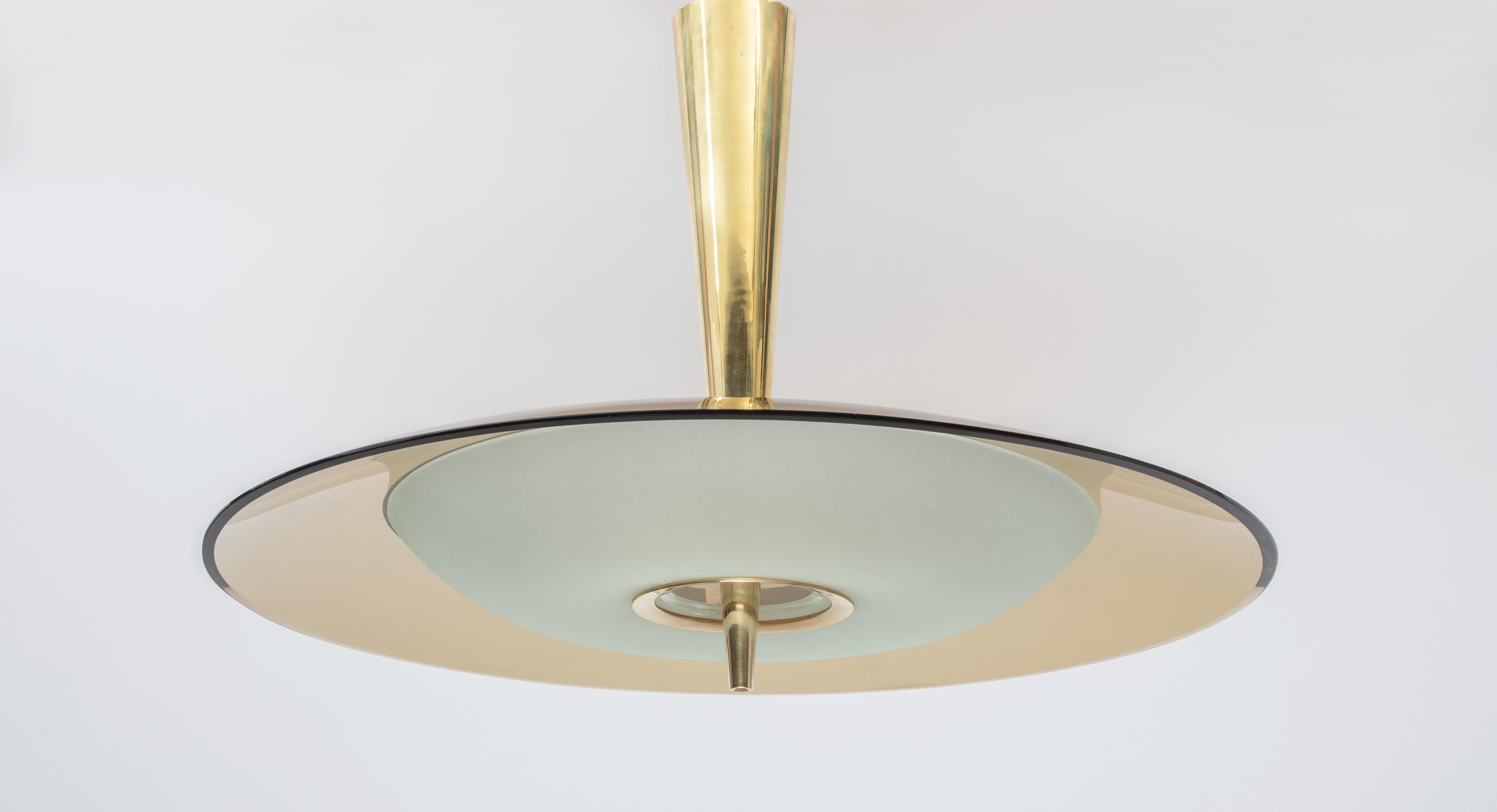 Max Ingrand (1908-1969) for Fontana Arte 
 
A stunning modernist chandelier by lighting pioneer Max Ingrand for Fontana Arte. A beautiful, large, and curved rose-colored glass shade arcs over a convex satin-finish glass bowl; the two are joined