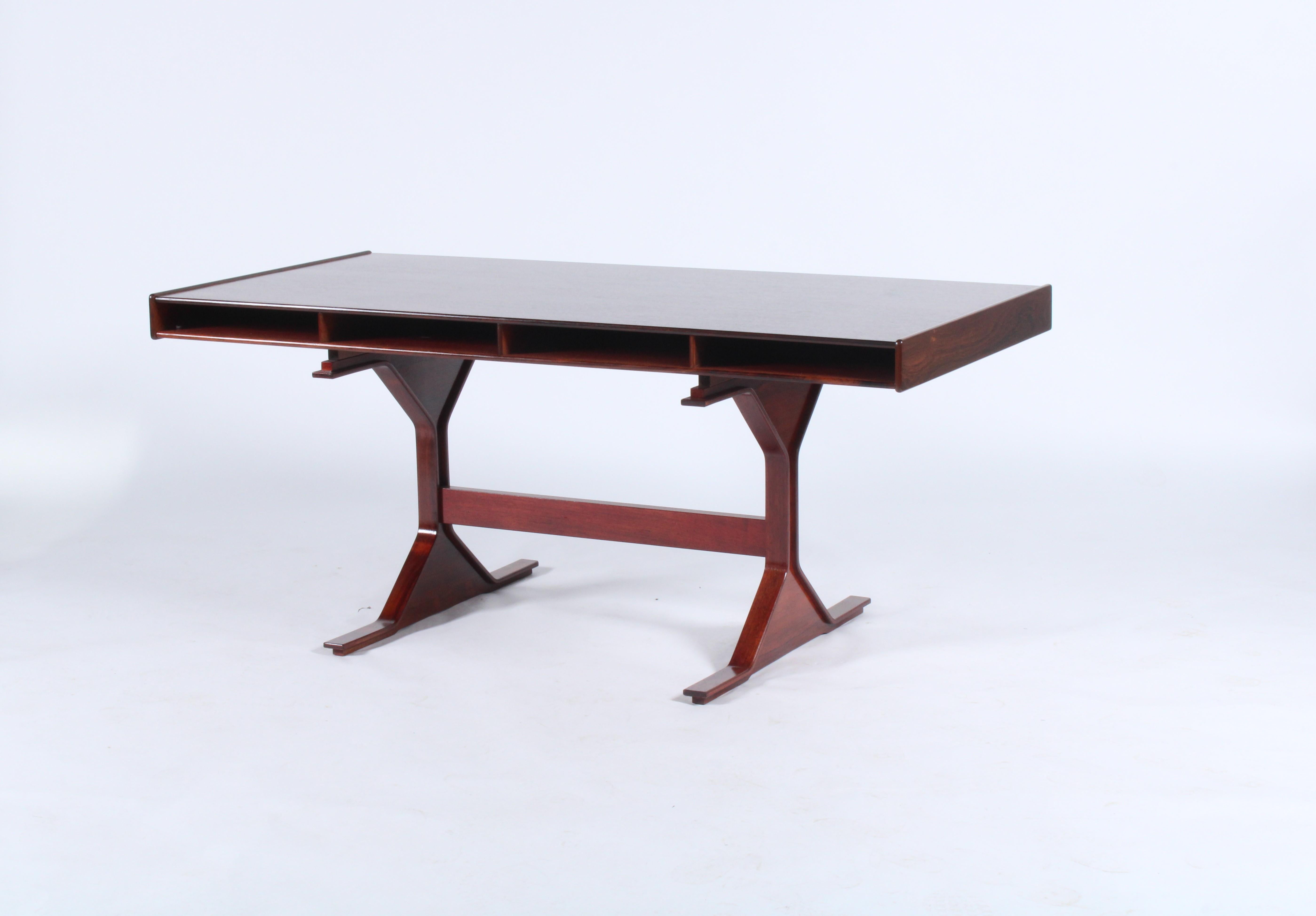 Exquisite vintage Italian desk in pallisandro wood circa 1960 by renowned designer Gianfranco Frattini. A large work surface area and ample drawer storage make this a most stylish, desirable and user friendly piece.Bearing the manufacturers original