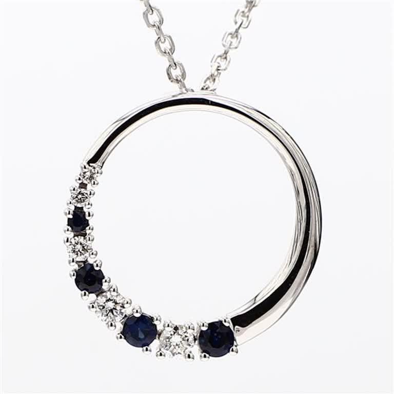 RareGemWorld's classic sapphire pendant. Mounted in a beautiful 14K White Gold setting with a natural round cut blue sapphires complimented by natural round cut white diamond melee. This pendant is guaranteed to impress and enhance your personal