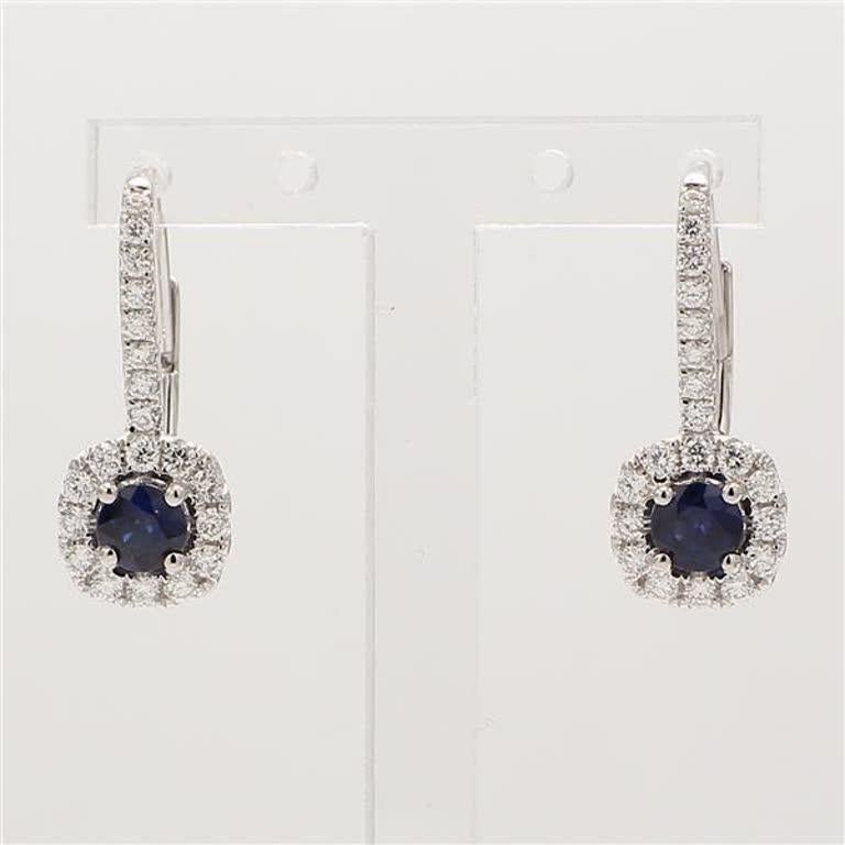 RareGemWorld's classic natural round cut sapphire earrings. Mounted in a beautiful 18K White Gold setting with natural round cut blue sapphires. The sapphires are surrounded by a single halo of natural round white diamond melee as well as diamonds