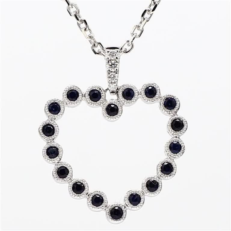 RareGemWorld's classic sapphire pendant. Mounted in a beautiful 14K White Gold setting with a natural round cut blue sapphires complimented by natural round cut white diamond melee in a beautiful heart-shape. This pendant is guaranteed to impress