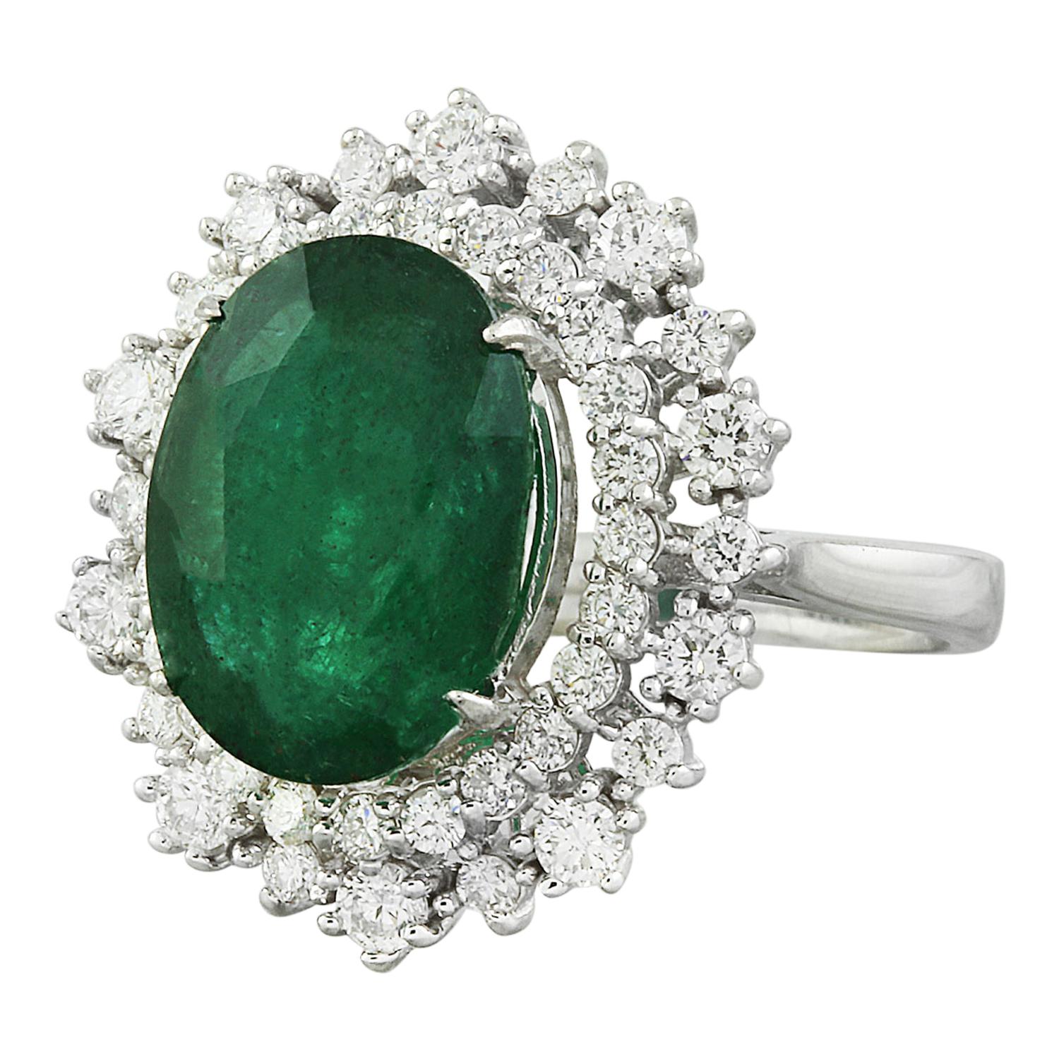 Introducing our captivating 7.15 Carat Natural Emerald 14K Solid White Gold Diamond Ring. This stunning piece features a stamped 14K white gold band, weighing a total of 6 grams. The star of the show is the breathtaking 6.00-carat emerald, measuring