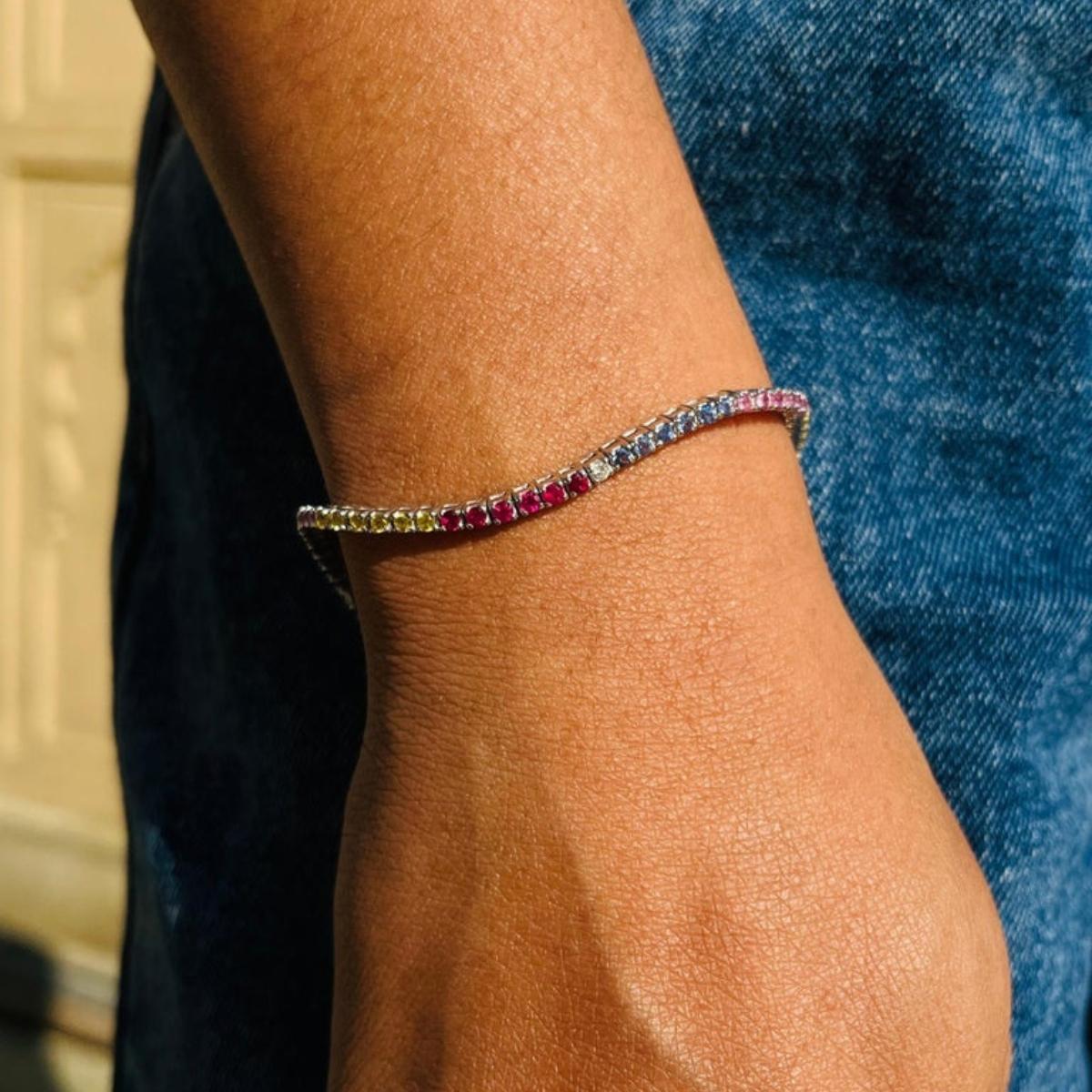 Exquisite Natural Multi Sapphire Thin Tennis Bracelet in 18k White Gold Jewelry showcases 75 endlessly sparkling natural sapphires, weighing 3.2 carats. It measures 7.25 inches long in length. 
Sapphire stimulate concentration and reduces