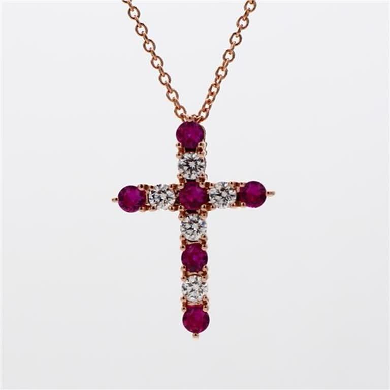 RareGemWorld's classic ruby pendant. Mounted in a beautiful 14K Rose Gold setting with a natural round cut red ruby's complimented by natural round cut white diamond melee in a beautiful cross-shape. This pendant is guaranteed to impress and enhance
