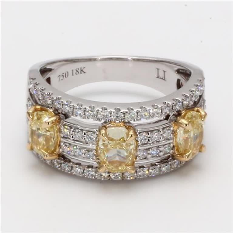 RareGemWorld's classic diamond band. Mounted in a beautiful 18K Yellow and White Gold setting with natural oval cut yellow diamonds. The yellow diamonds are surrounded by small round natural white diamond melee. This band is guaranteed to impress