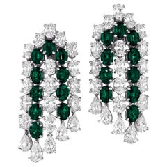 exquisite oval and cushion-shaped emeralds and diamonds dangle earrings