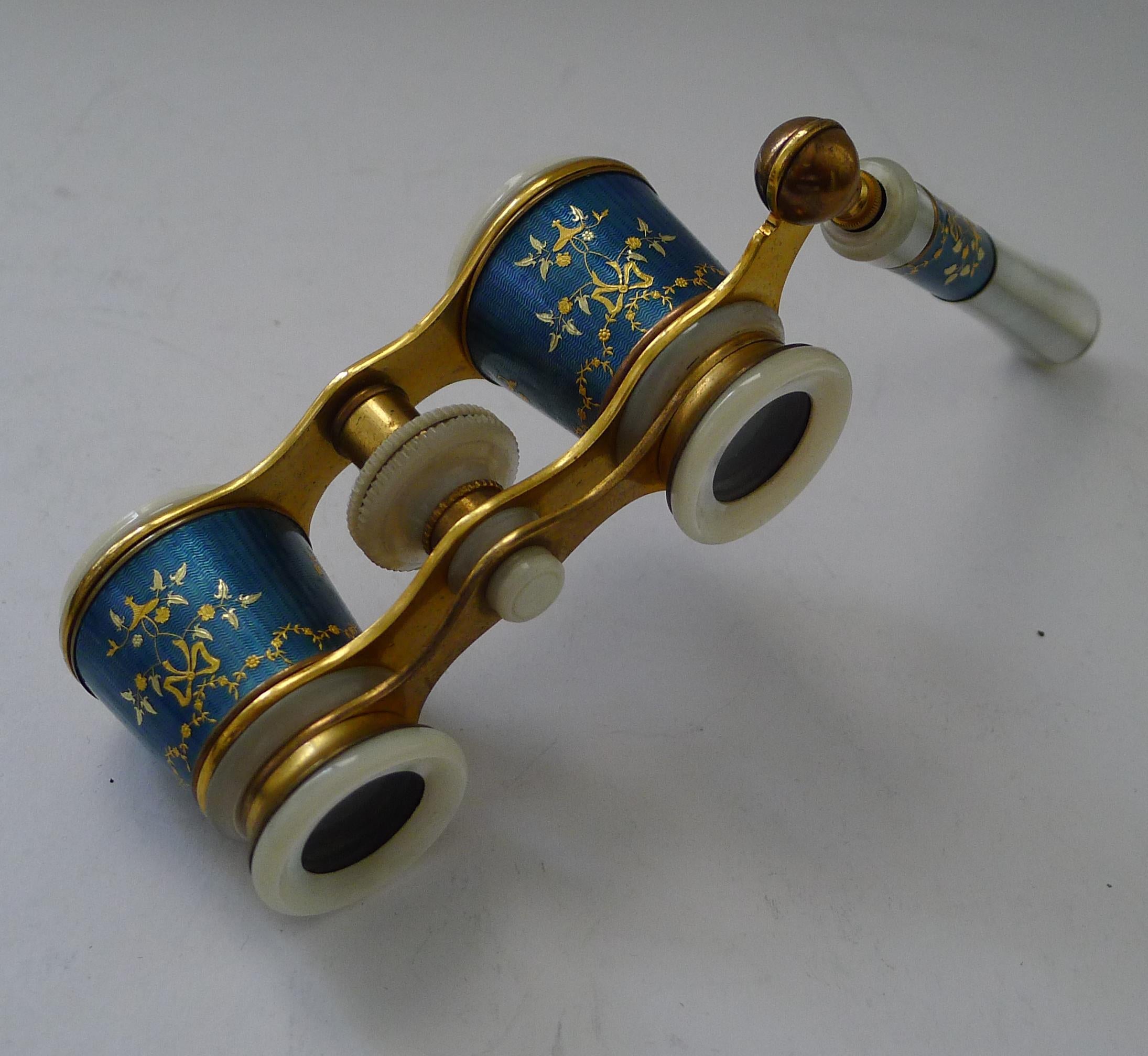 A truly superb pair of blue enamel opera glasses with intricate inlay and polished Mother of Pearl trim.

The metalware retains it's original gilding.  They have a telescopic lorgnette handle.  In full working order and complete with a protective